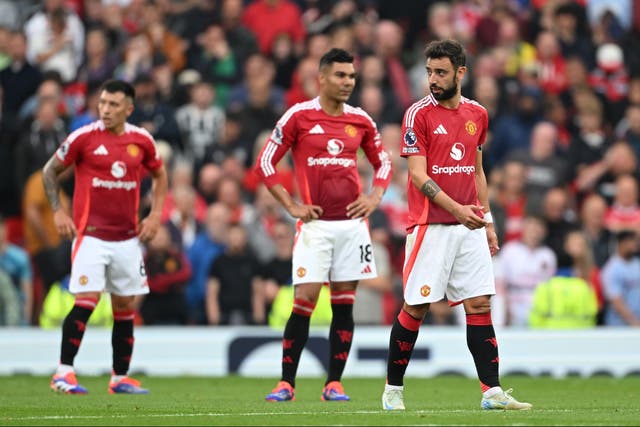 <p>Manchester United players react during the defeat by Liverpool </p>