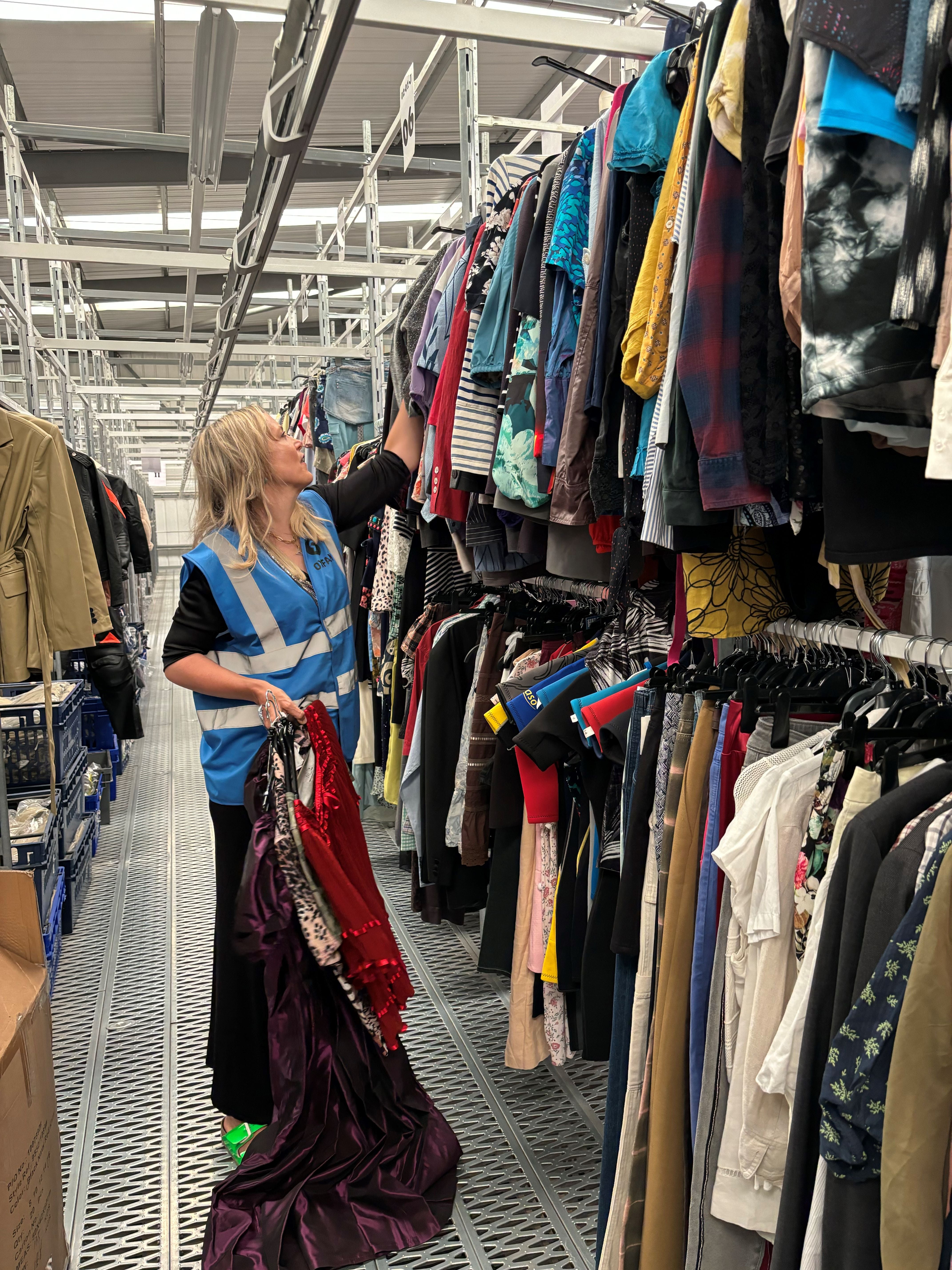 Bay Garnett searches through the rails of an Oxfam warehouse in Milton Keynes. (Oxfam)