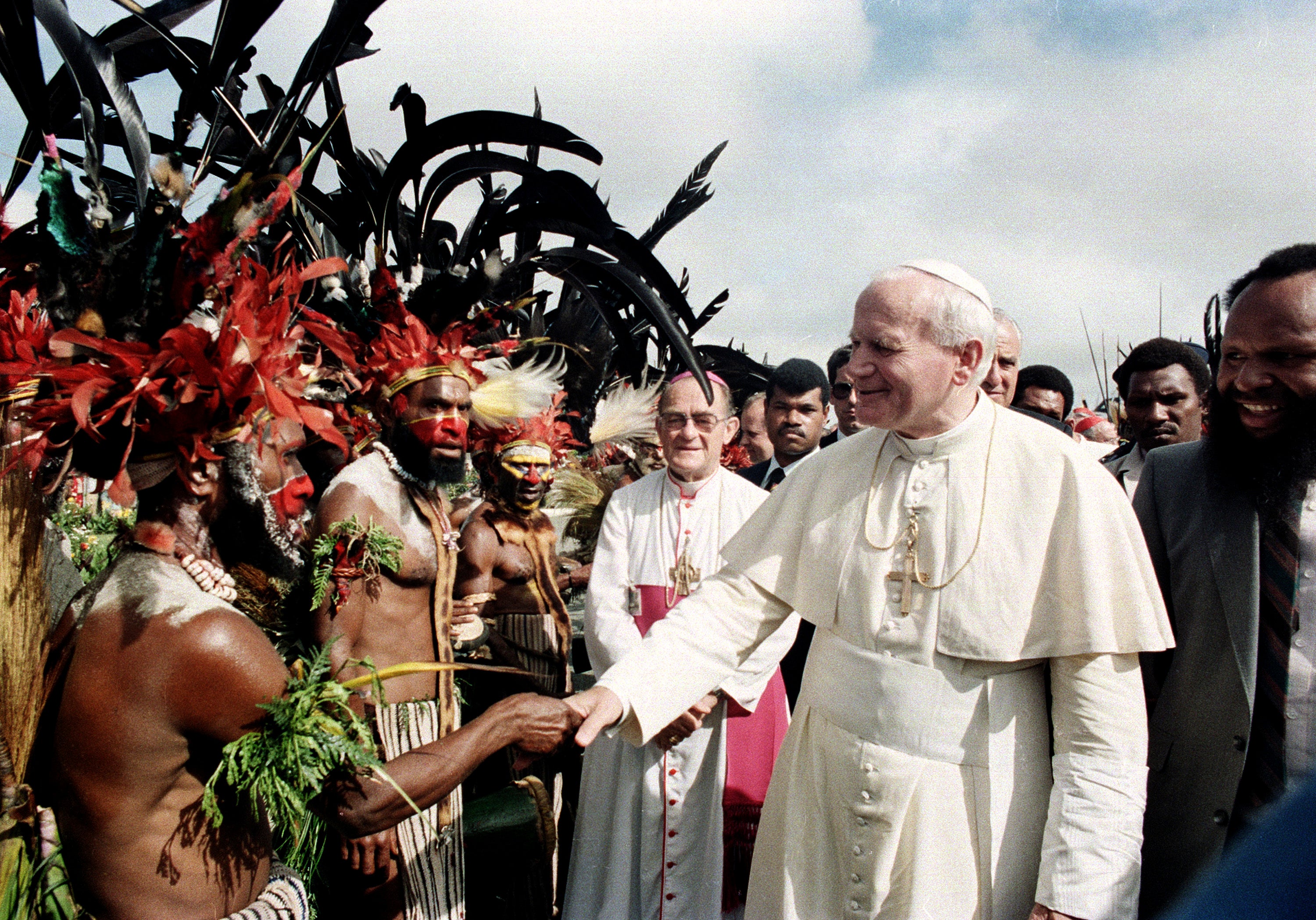 Pope John Paul II is greeted by Papua New Guinea Highland natives on his visit to Mt. Hagen, New Guinea, Tuesday, May 8, 1984. (AP Photo/File)