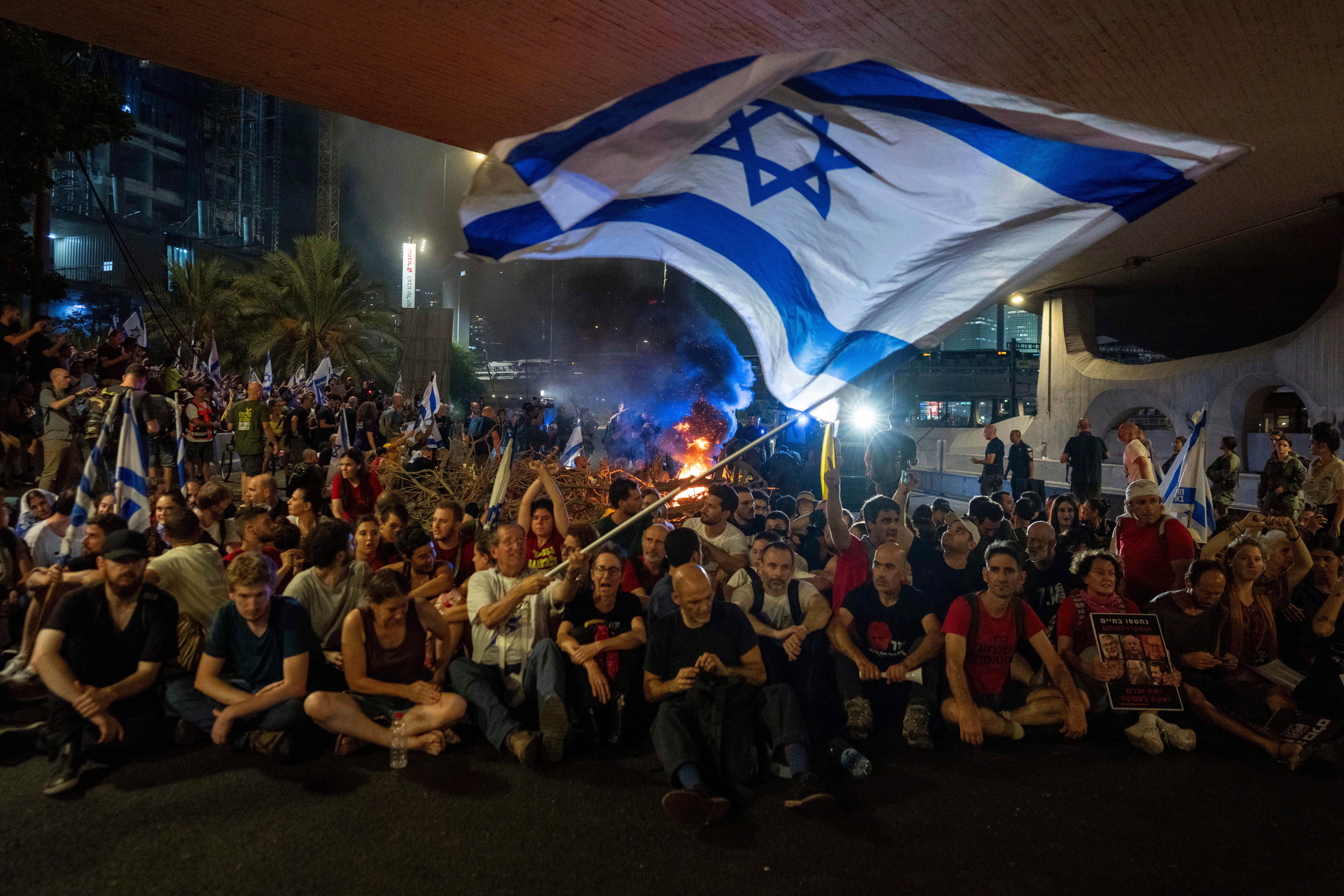 People block a road as they protest, calling for a deal for the immediate release of hostages held in the Gaza Strip by Hamas, September 1