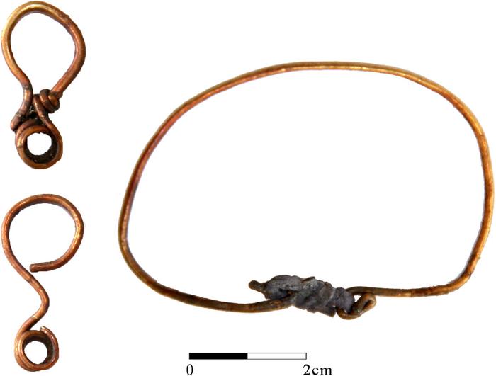 Gold bracelet and two earrings found in grave