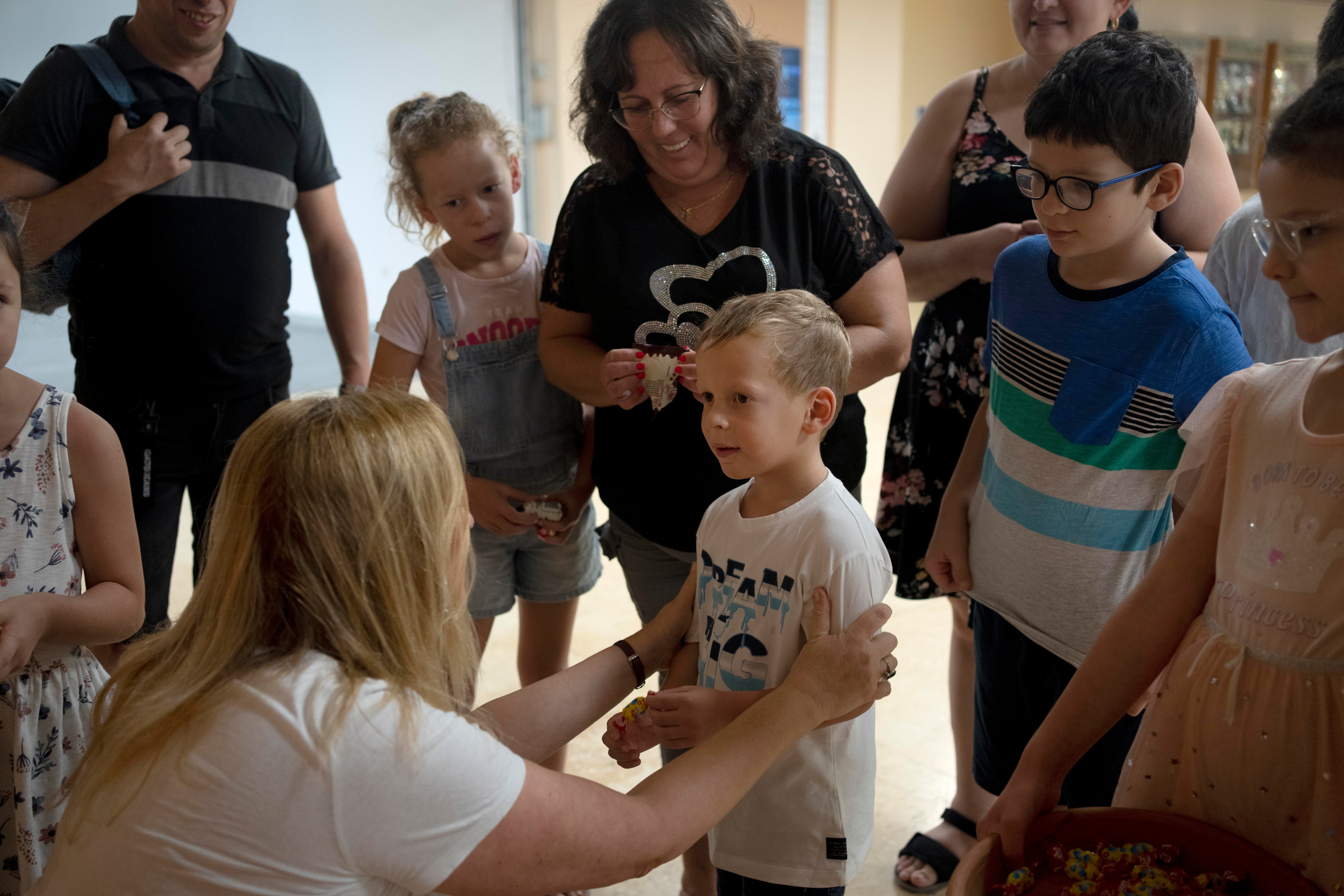 Ariel Geller is welcomed by Inbal Rivlin for a special tour after the child accidentally broke an ancient jar at the Reuben and Edith Hecht Museum in Haifa