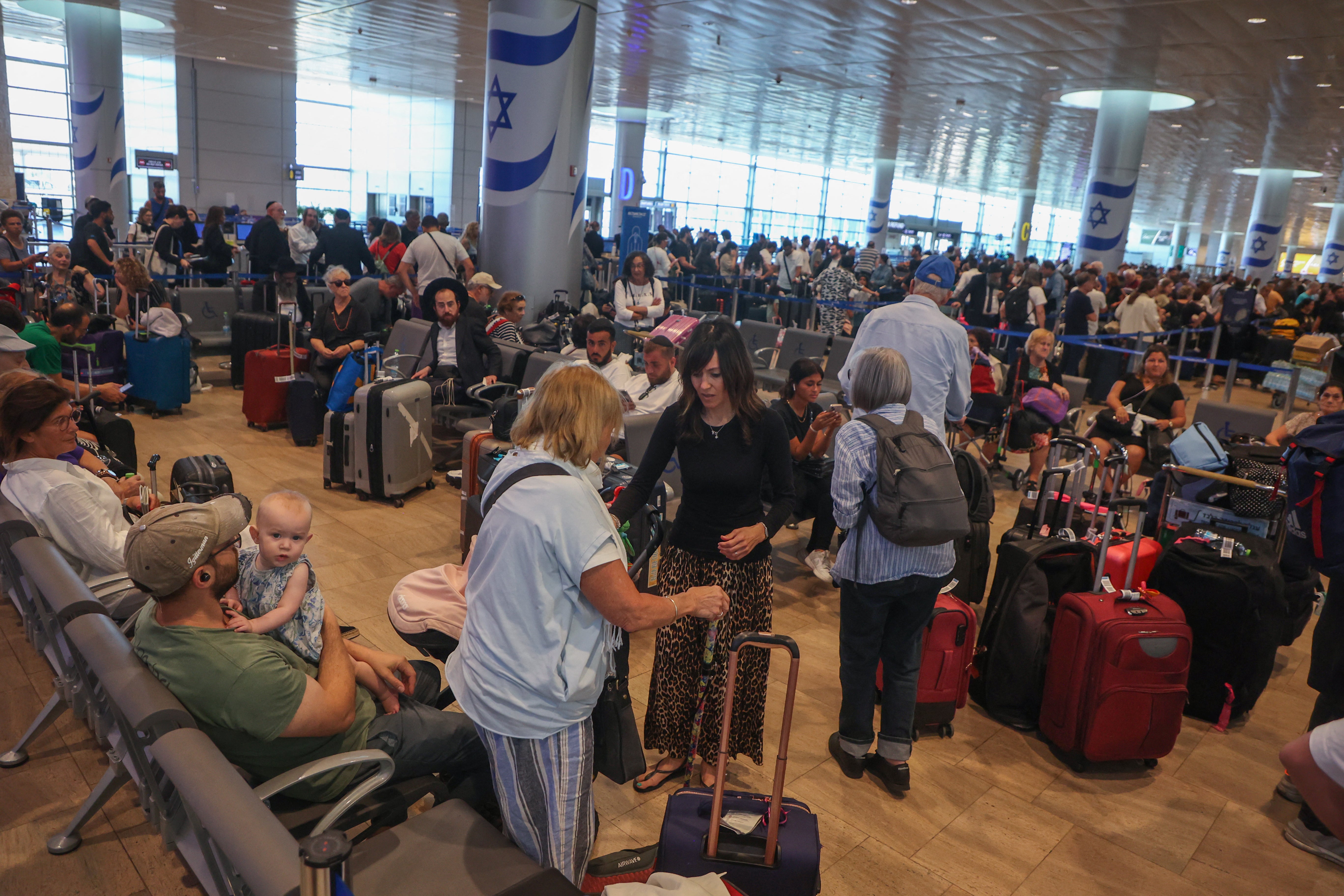 Passengers wait for flights at the Ben Gurion Airport in Tel Aviv during a nationwide strike on Monday