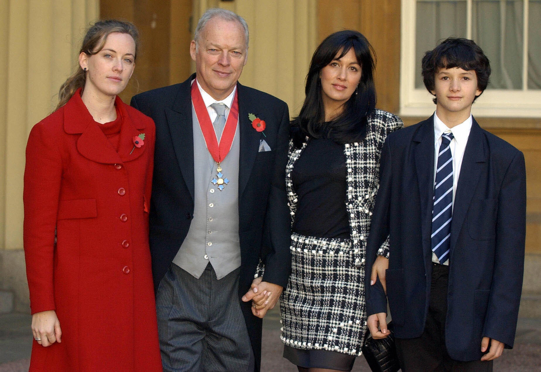 Gilmour with (L-R) daughter Alice, wife Polly and son Charlie at Buckingham Palace, 2003, after receiving a CBE for services to music