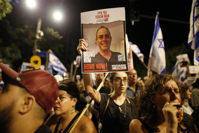 <p>Israelis gather with banners and flags in front of the residence of Israeli Prime Minister Benjamin Netanyahu on Monday night amid calls for a ceasefire with Hamas and the release of hostages</p>