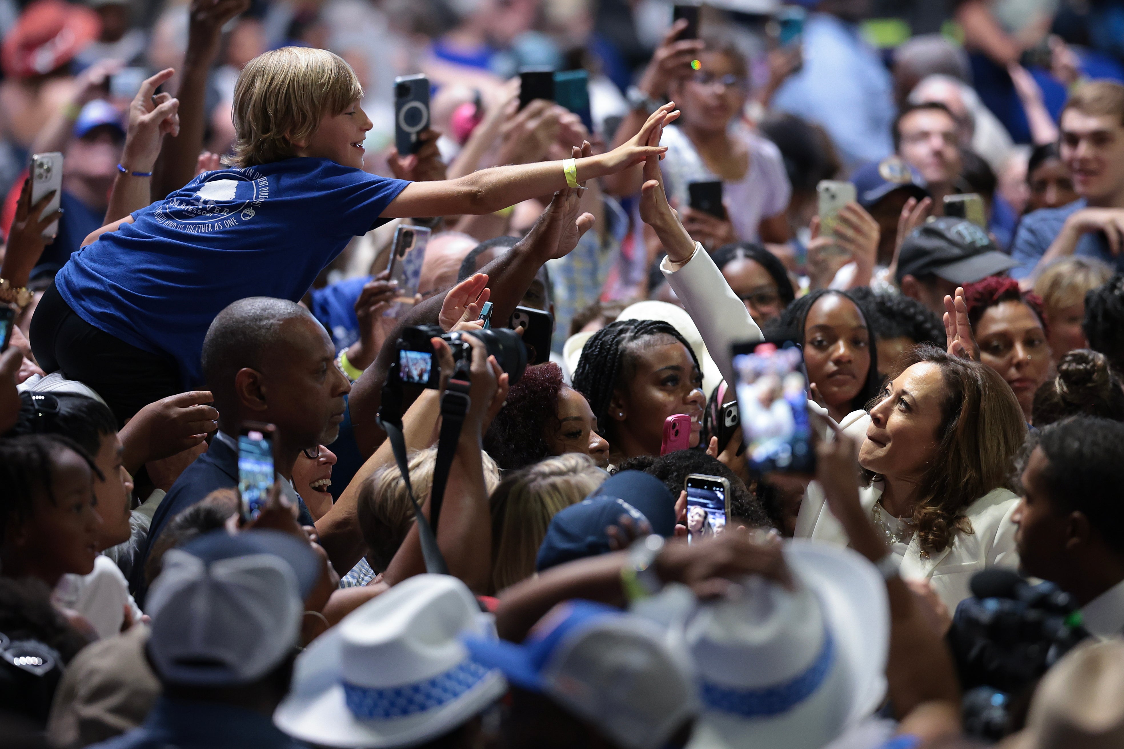 Vice President Kamala Harris gives a young rally attendee a high-five in Georgia