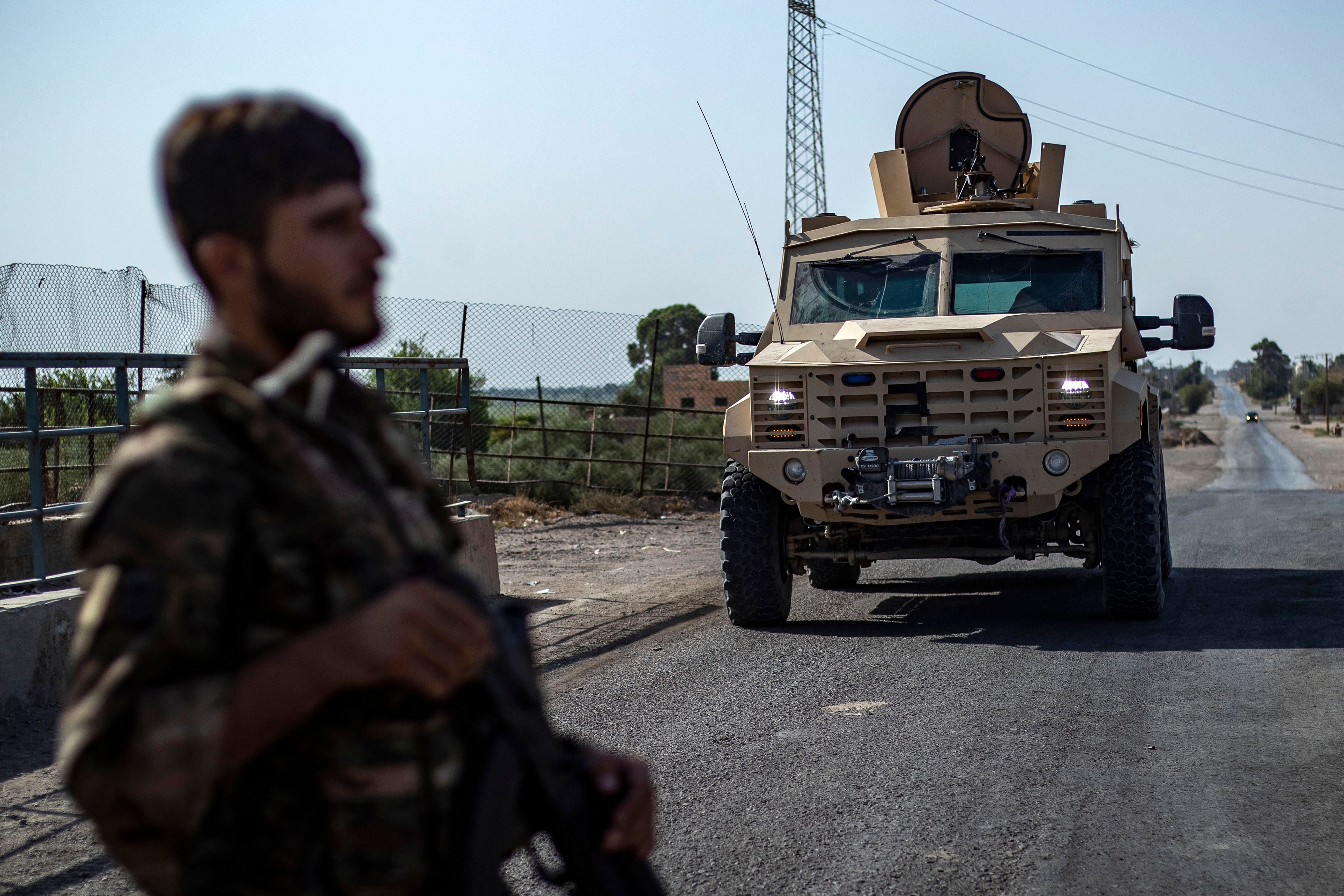 A fighter of the Syrian Democratic Forces (SDF) stands guard along a road in Syria's northeastern on September 4, 2023. The US military teamed up with the SDF to capture an Isis leader who helped detainees escape