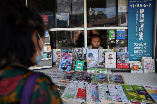 <p>File. A woman shops at a news stand where a book about Chinese President Xi Jinping is displayed in Beijing on 24 August 2020</p>