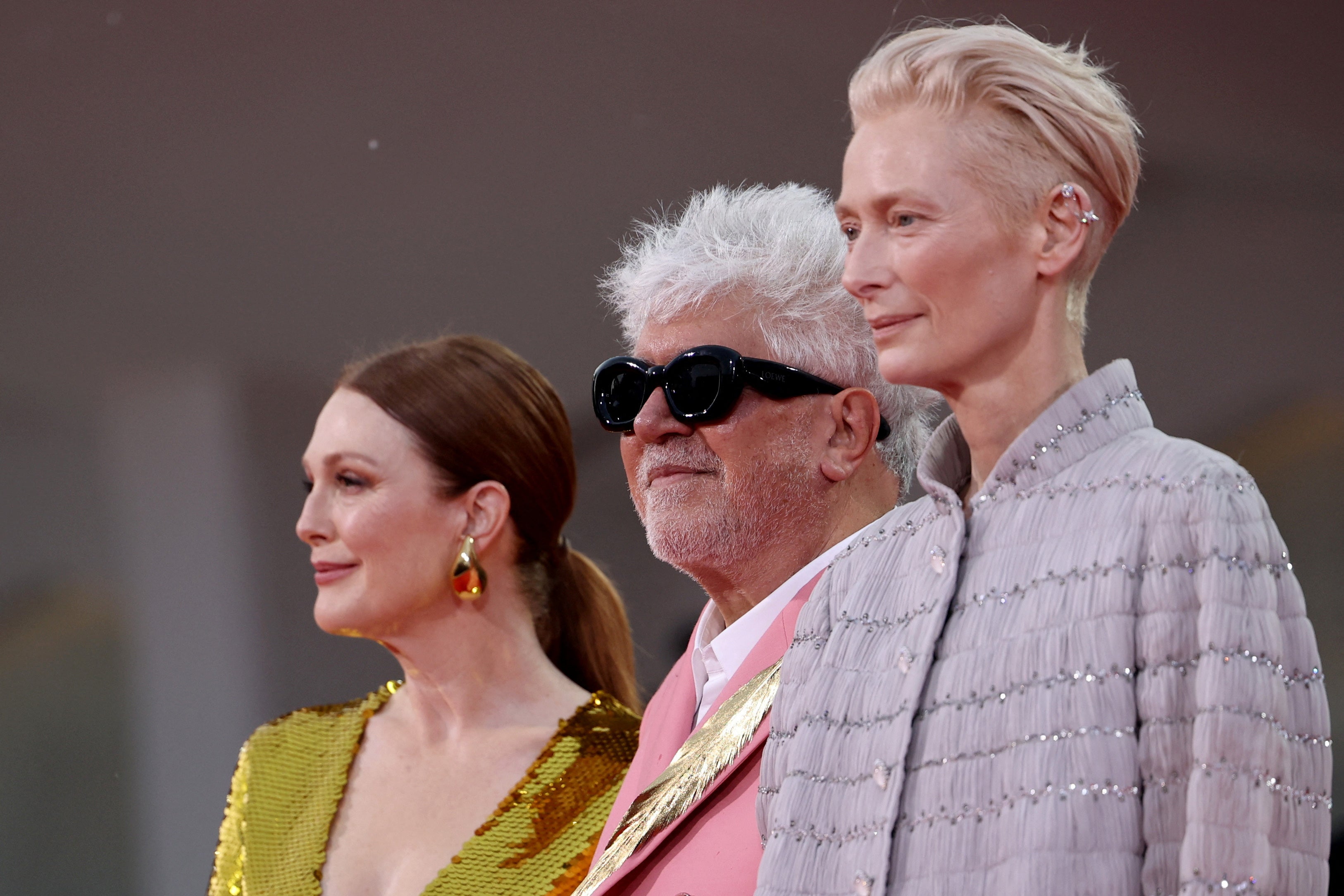 Pedro Almodovar, Julianne Moore and Tilda Swinton pose on the red carpet ahead of the premiere of The Room Next Door at the Venice Film Festival