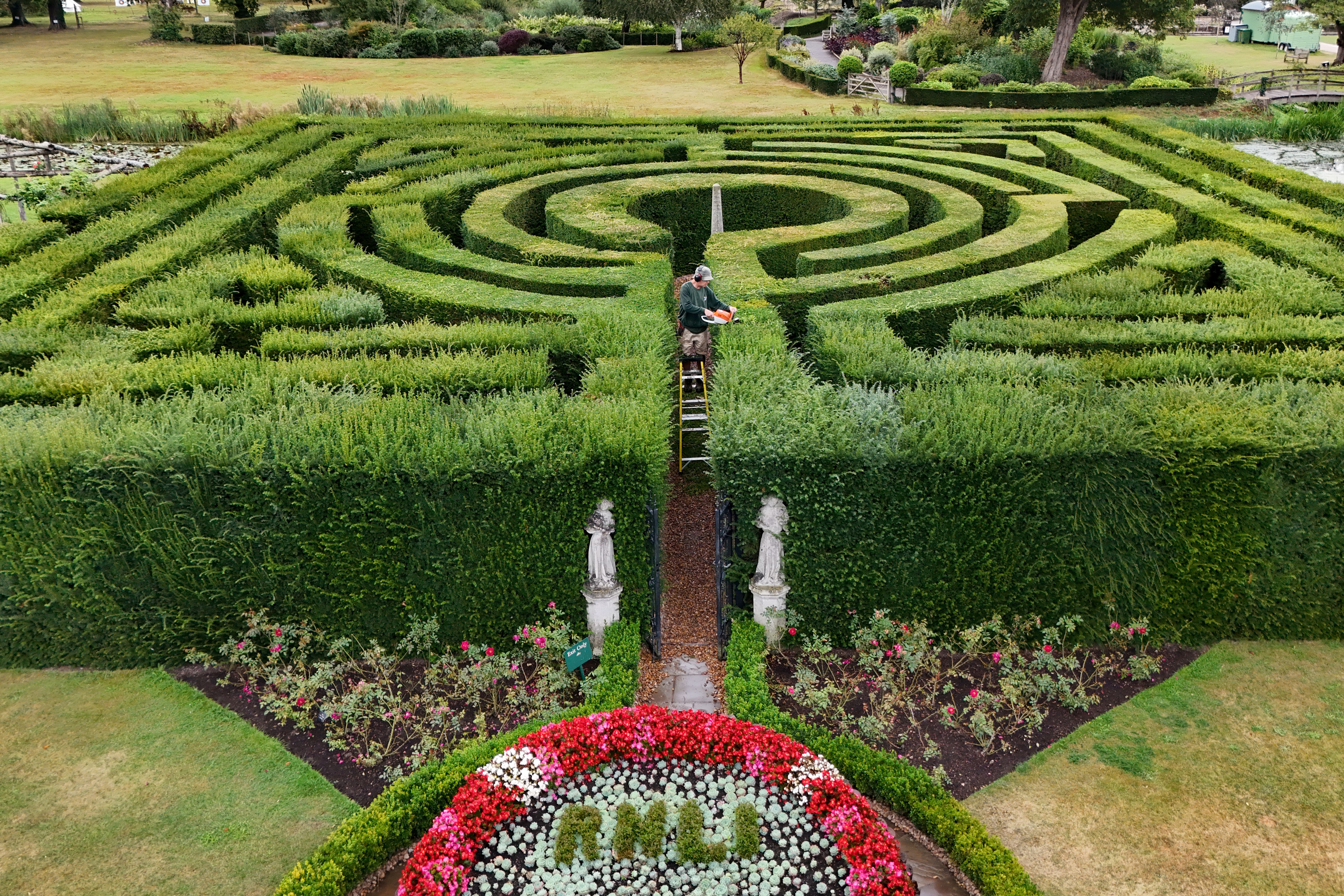 A gardener at Hever Castle tends to the bushes that makes up the120-year-old maze (Gareth Fuller/PA)