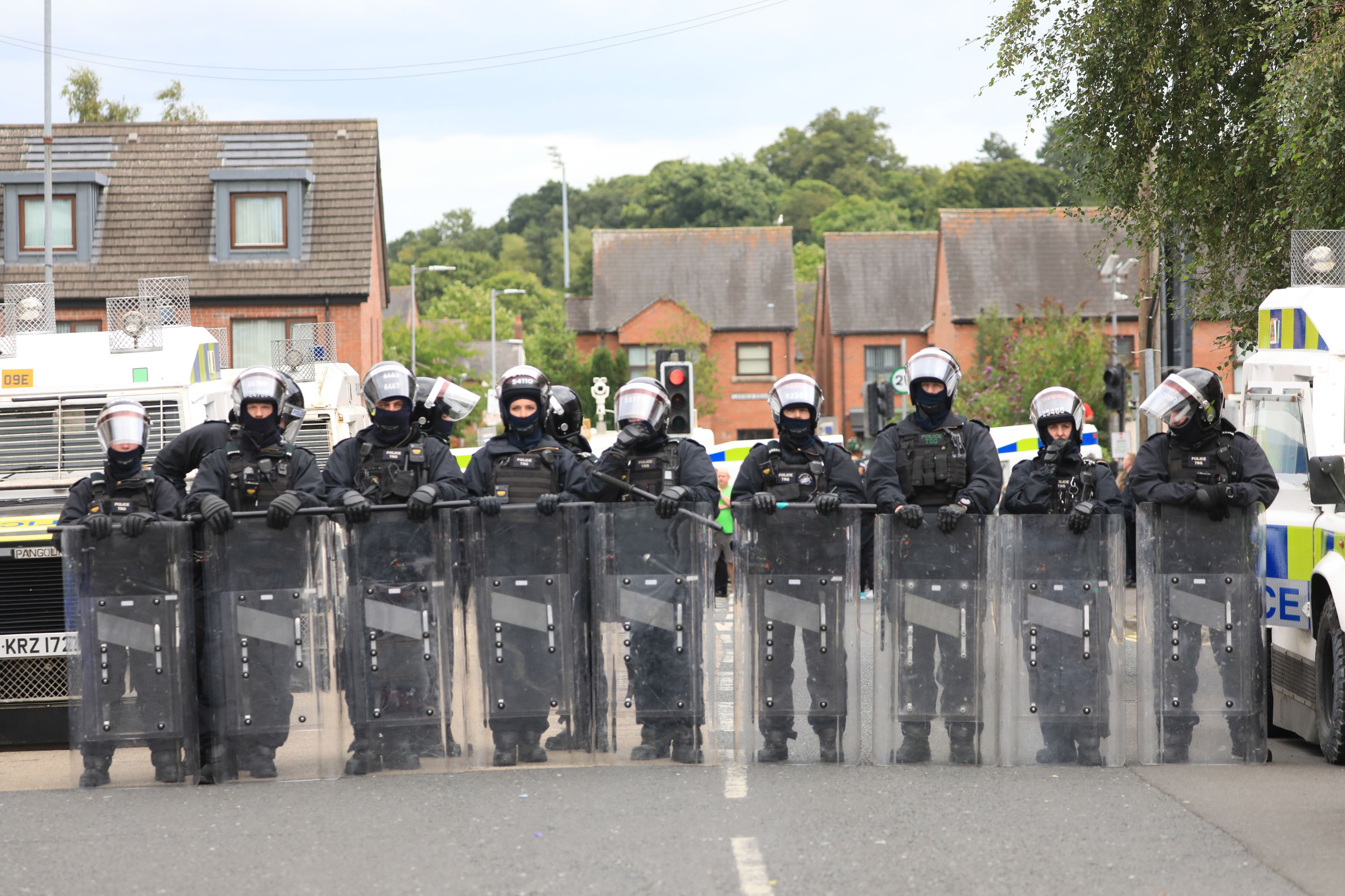 Riot police form a line on a road following a protest outside Belfast City Hall (Peter Morrison/PA)