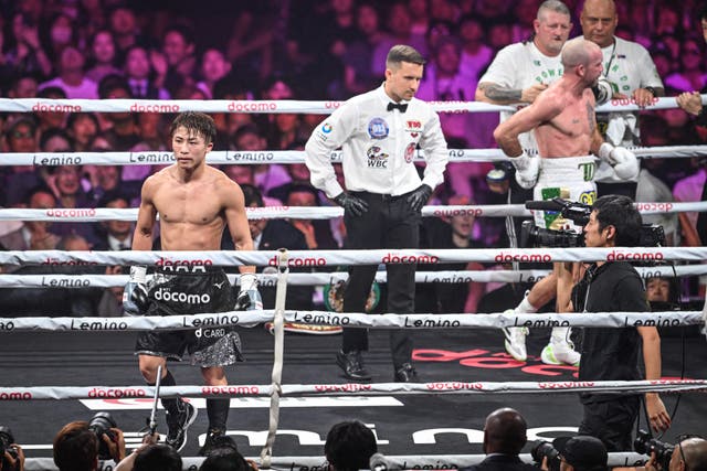 <p>TJ Doheny clutches his hip or lower back after his fight with Naoya Inoue is waved off</p>
