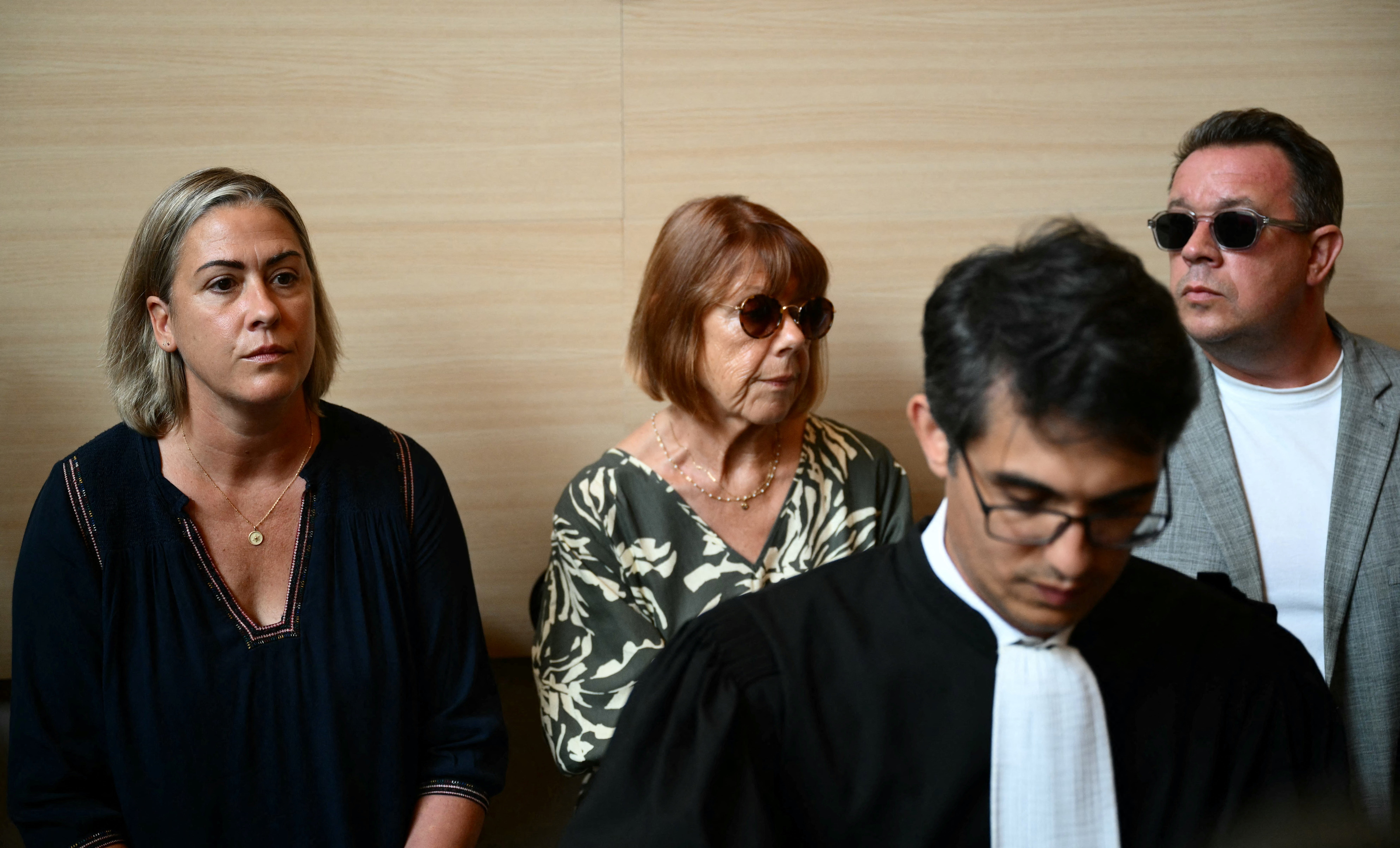 Gisele Pelicot (centre) sits beside her daughter Caroline Darian (left) and her son at the courthouse during the trial of her husband