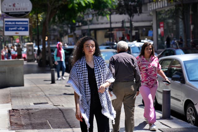 <p>Plestia Alaqad, a young Palestinian journalist, walks in Hamra street in Beirut, Lebanon, Tuesday, Sept. 3, 2024. (AP Photo/Hussein Malla)</p>