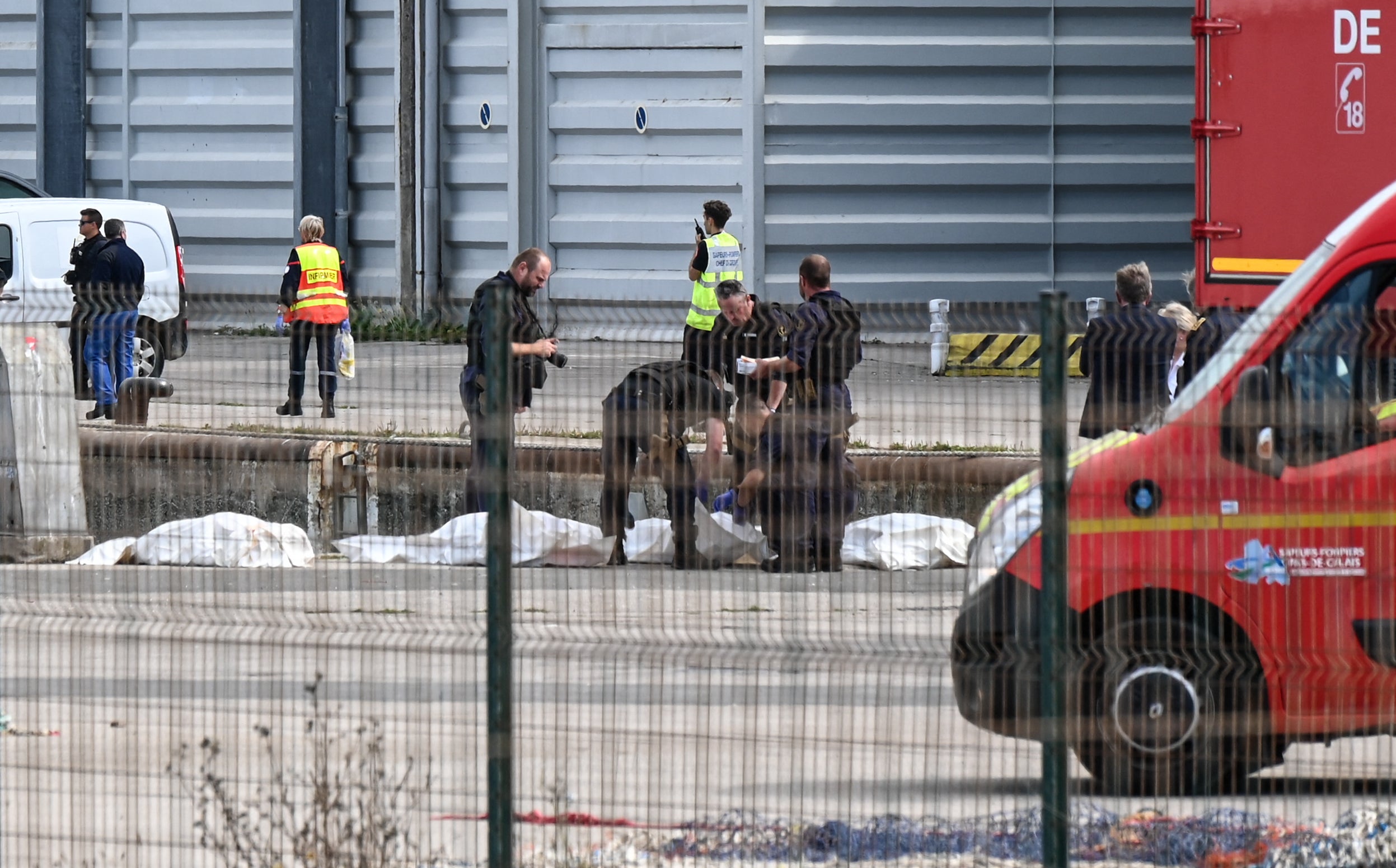 Bodies of migrants who died attempting to cross the Channel are brought ashore in Boulogne-sur-Mer, northern France, on Tuesday