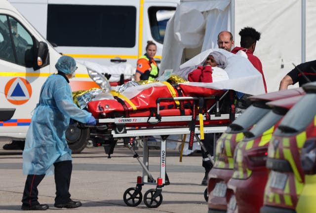 <p>A survivor is taken for treatment in France after the sinking of a migrant boat near Boulogne-sur-Mer on Tuesday</p>