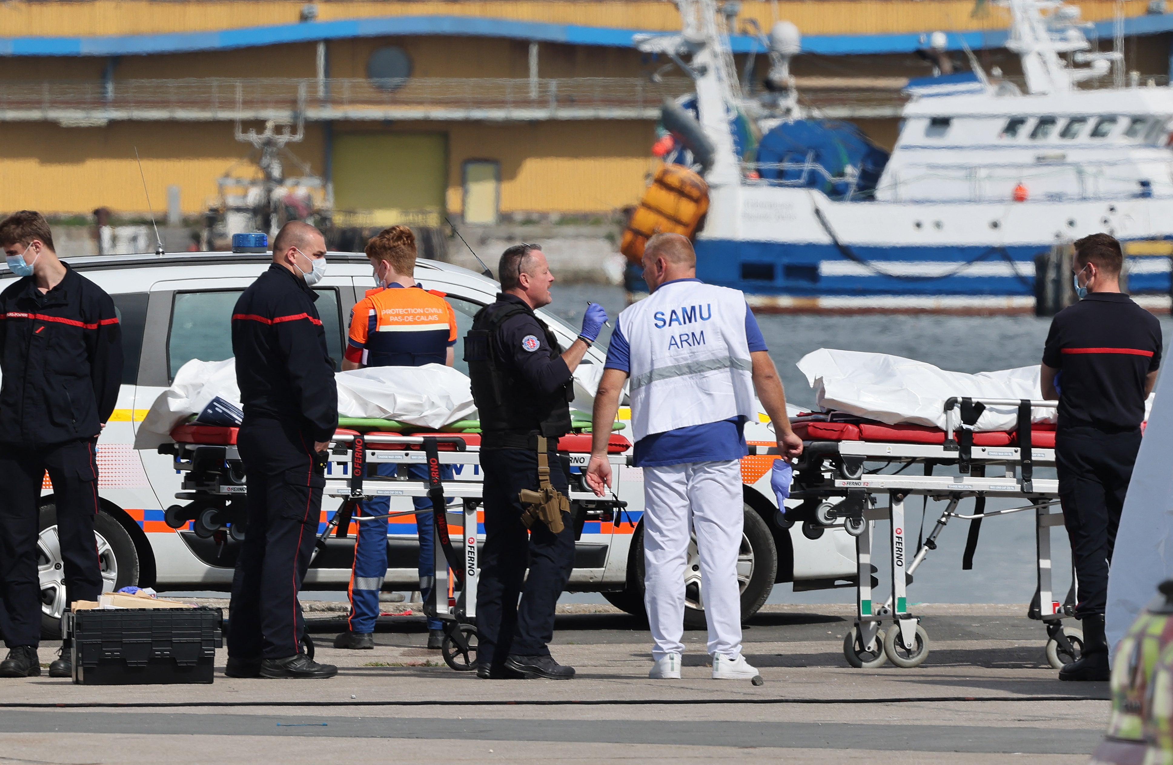 Bodies of migrants who died attempting to cross the Channel are brought ashore in Boulogne-sur-Mer, northern France, on Tuesday