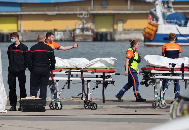 <p>The bodies of people who died attempting to cross the Channel are brought ashore in Boulogne-sur-Mer, northern France, on Tuesday</p>