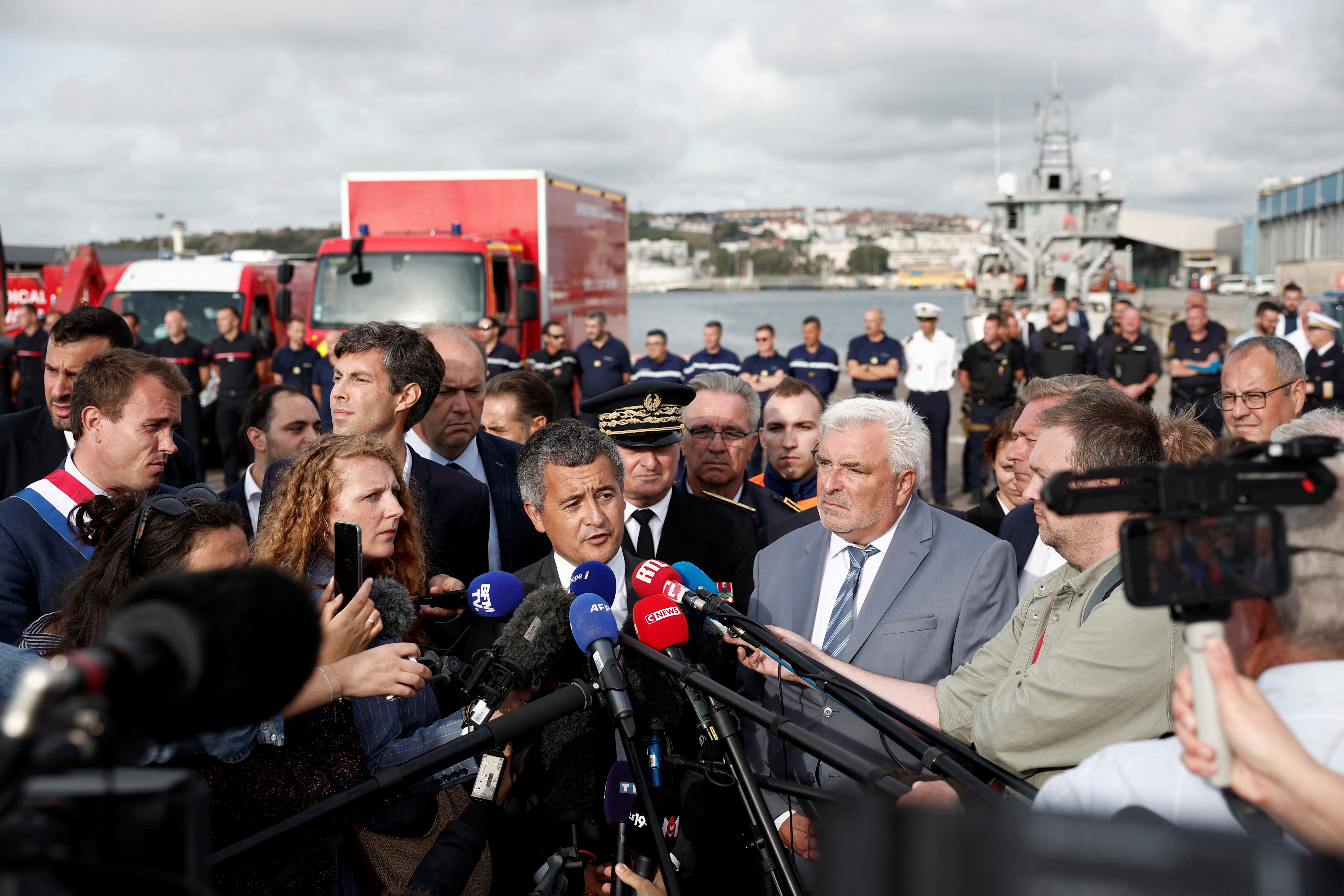 French Interior Minister Gerald Darmanin speaks to media after several migrants died as their boat capsized