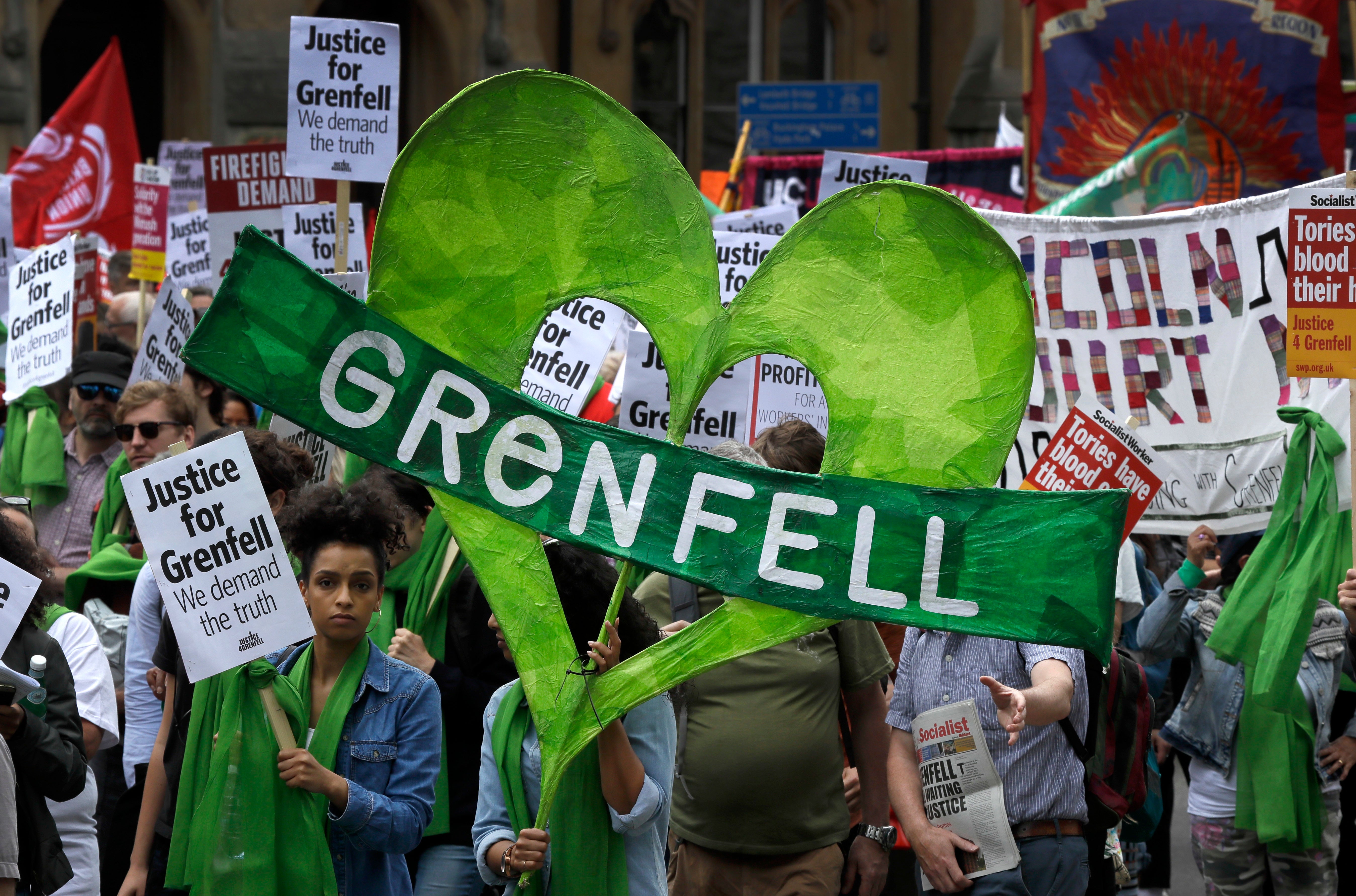 Demonstrators march in the Grenfell fire one year anniversary