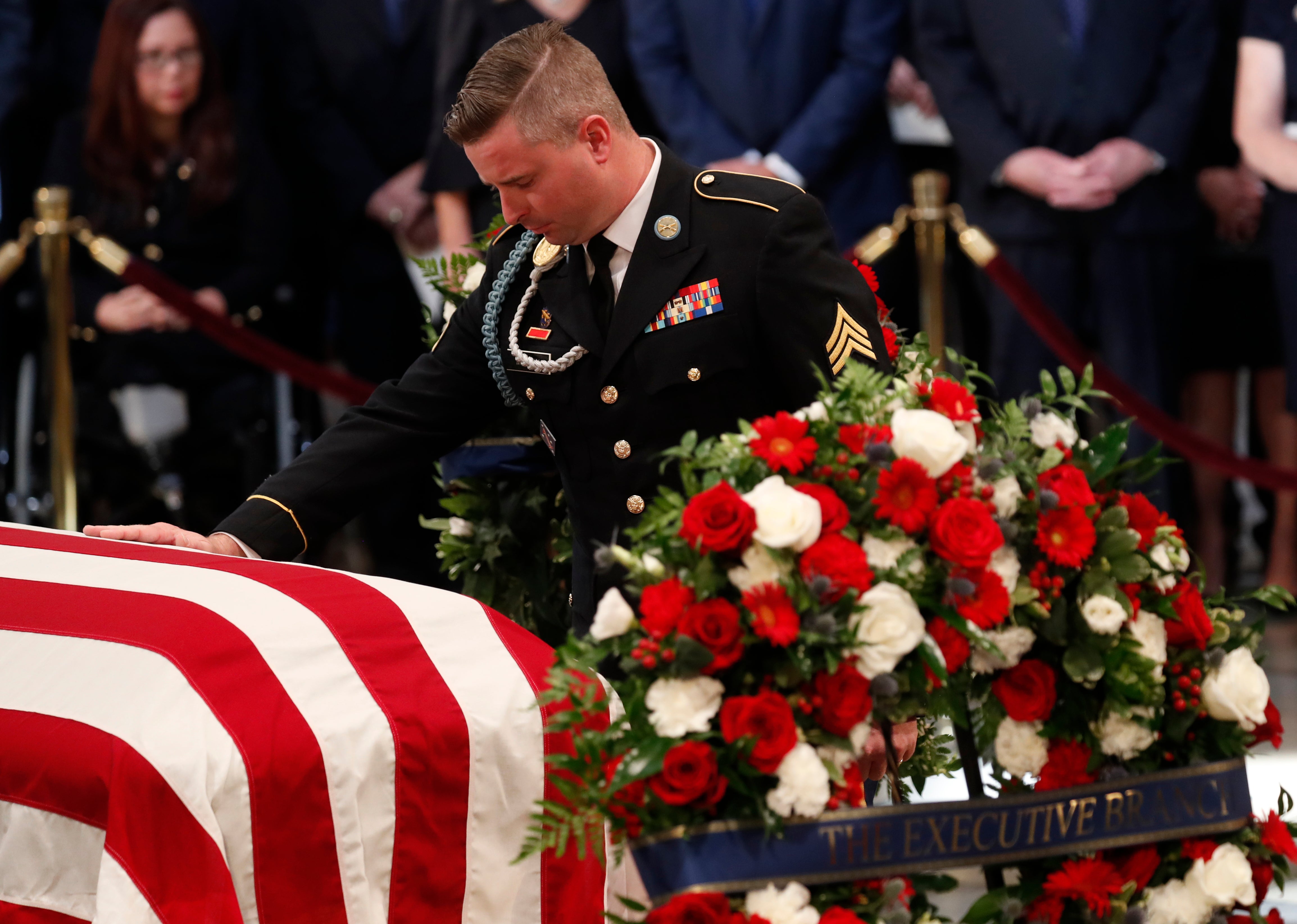 Jimmy McCain, son of late U.S. Senator John McCain, touches his father’s casket during ceremonies honoring the late US Senator John McCain inside the Rotunda of the U.S. Capitol, August 31, 2018. Now, he is blasting Donald Trump over the Republican nominee’s visit to Arlington.