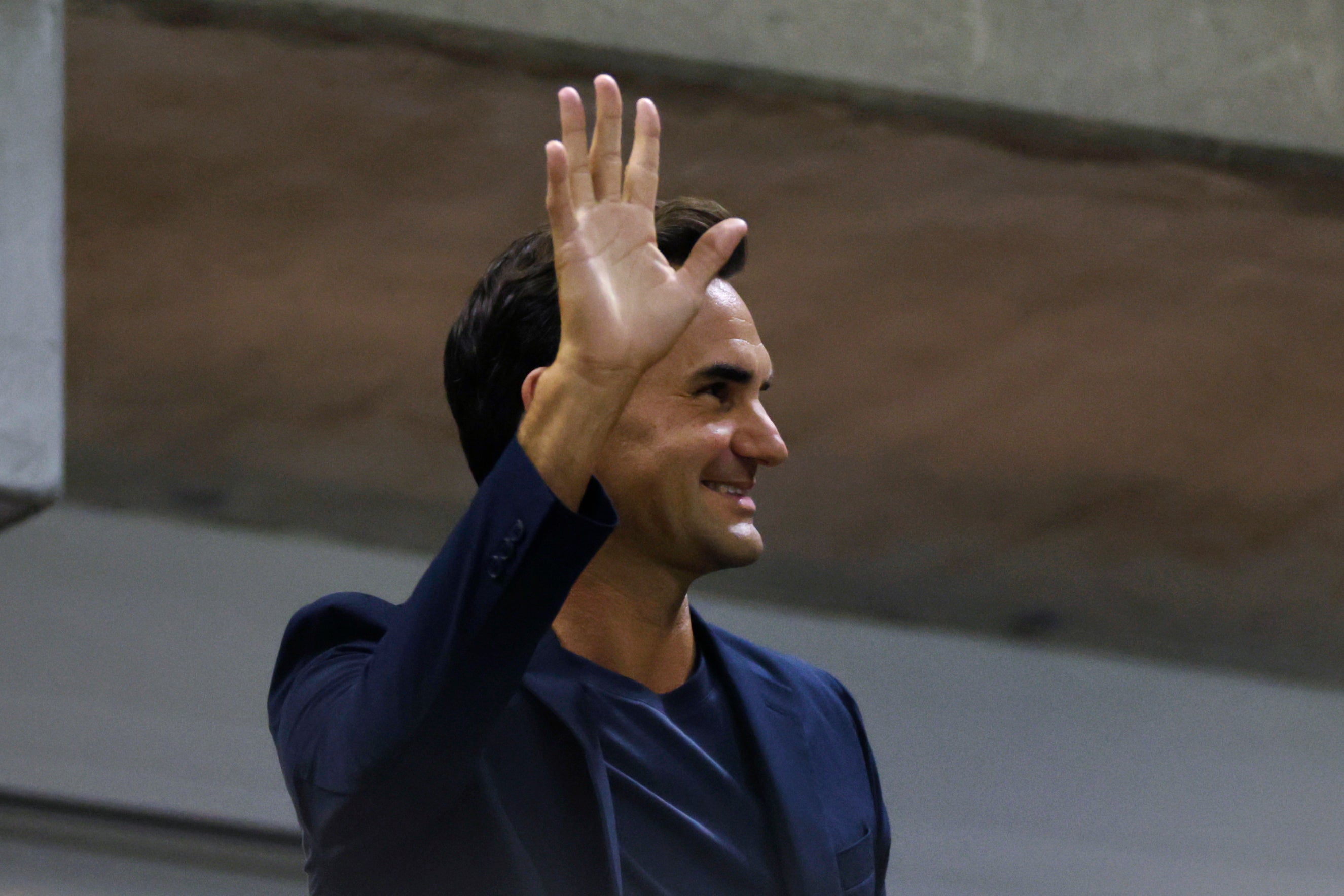 Tennis great Roger Federer waves to the crowd during the quarterfinal match between Aryna Sabalenka, of Belarus, and Zheng Qinwen, of China, during the U.S. Open tennis championships, Tuesday, Sept. 3, 2024, in New York. (AP Photo/Adam Hunger)