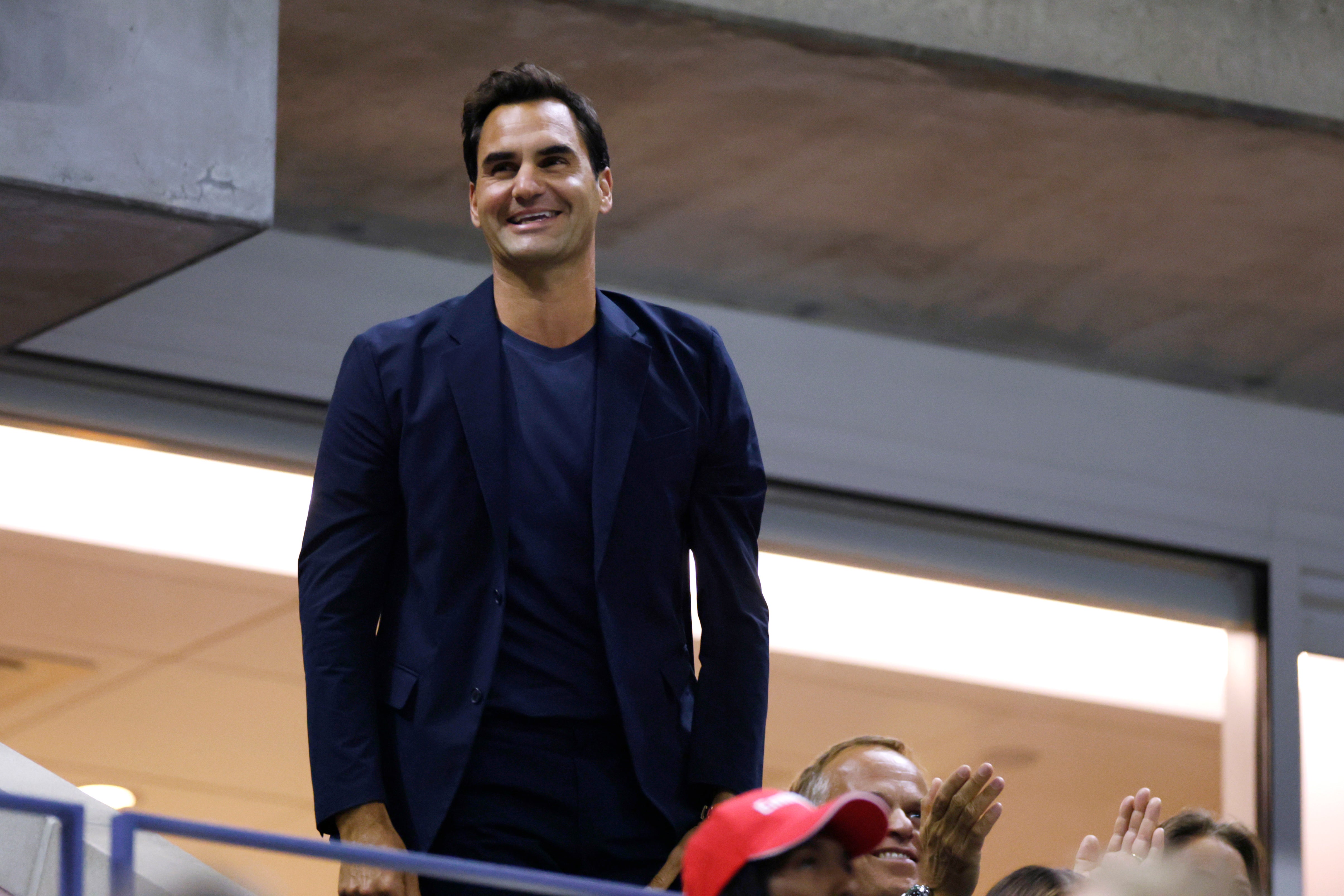 Tennis great Roger Federer acknowledges the crowd during the quarterfinal match between Aryna Sabalenka, of Belarus, and Zheng Qinwen, of China, during the U.S. Open tennis championships, Tuesday, Sept. 3, 2024, in New York. (AP Photo/Adam Hunger)