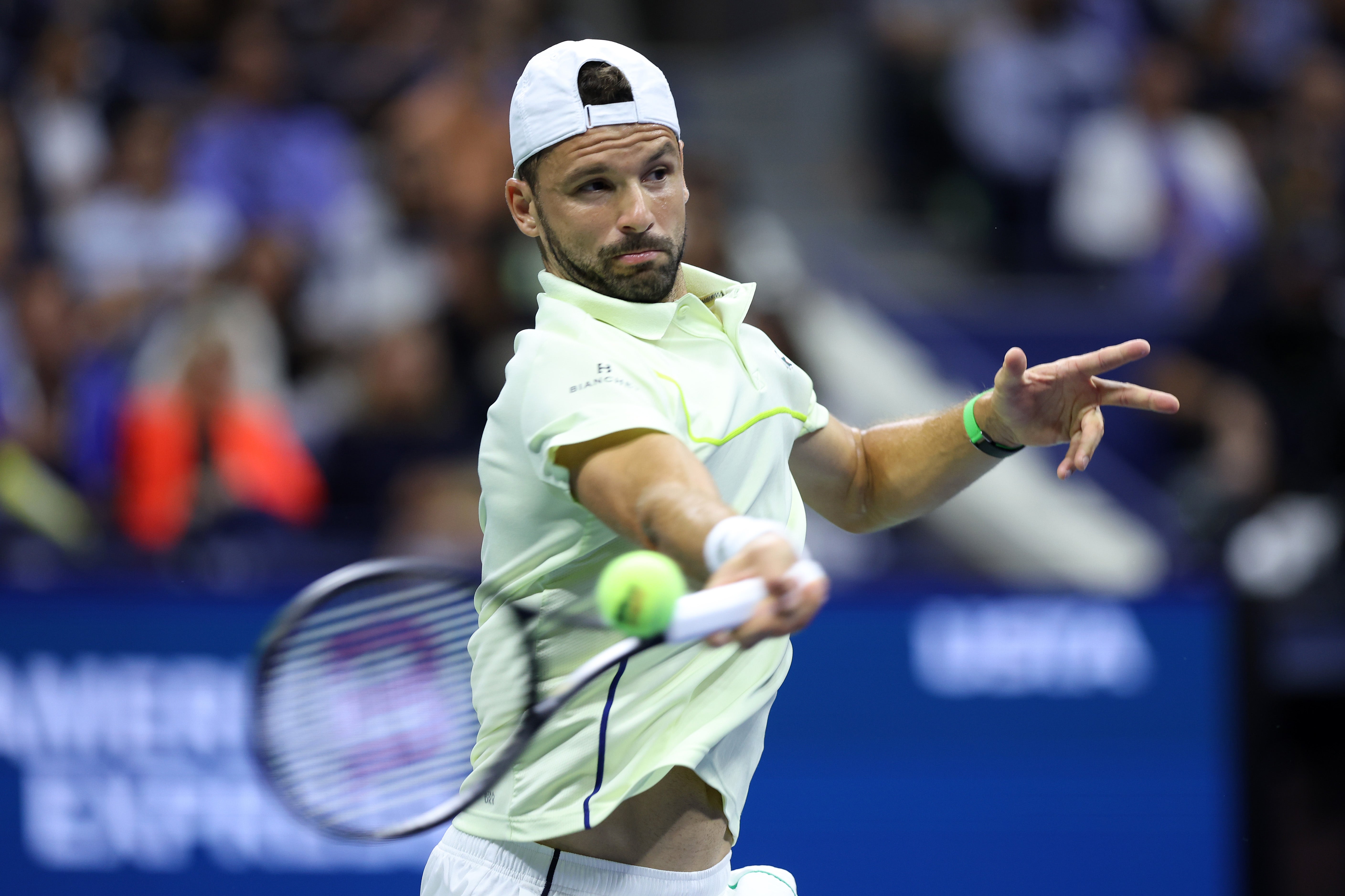 Grigor Dimitrov of Bulgaria returns a shot against Frances Tiafoe of the United States during their Men's Singles Quarterfinal match on Day 9