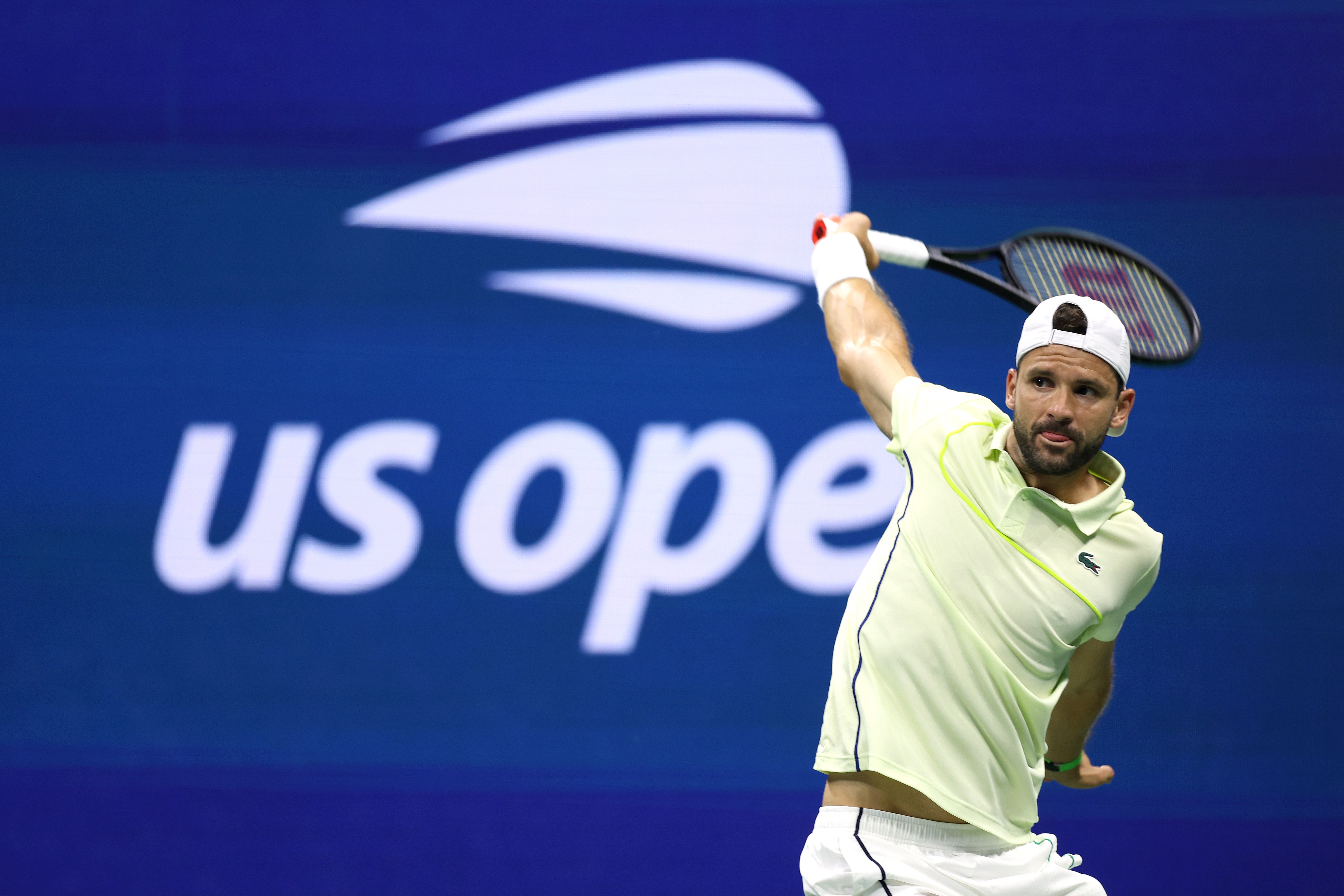 NEW YORK, NEW YORK - SEPTEMBER 03: Grigor Dimitrov of Bulgaria returns a shot against Frances Tiafoe of the United States during their Men's Singles Quarterfinal match on Day Nine of the 2024 US Open at USTA Billie Jean King National Tennis Center on September 03, 2024 in the Flushing neighborhood of the Queens borough of New York City. (Photo by Jamie Squire/Getty Images)