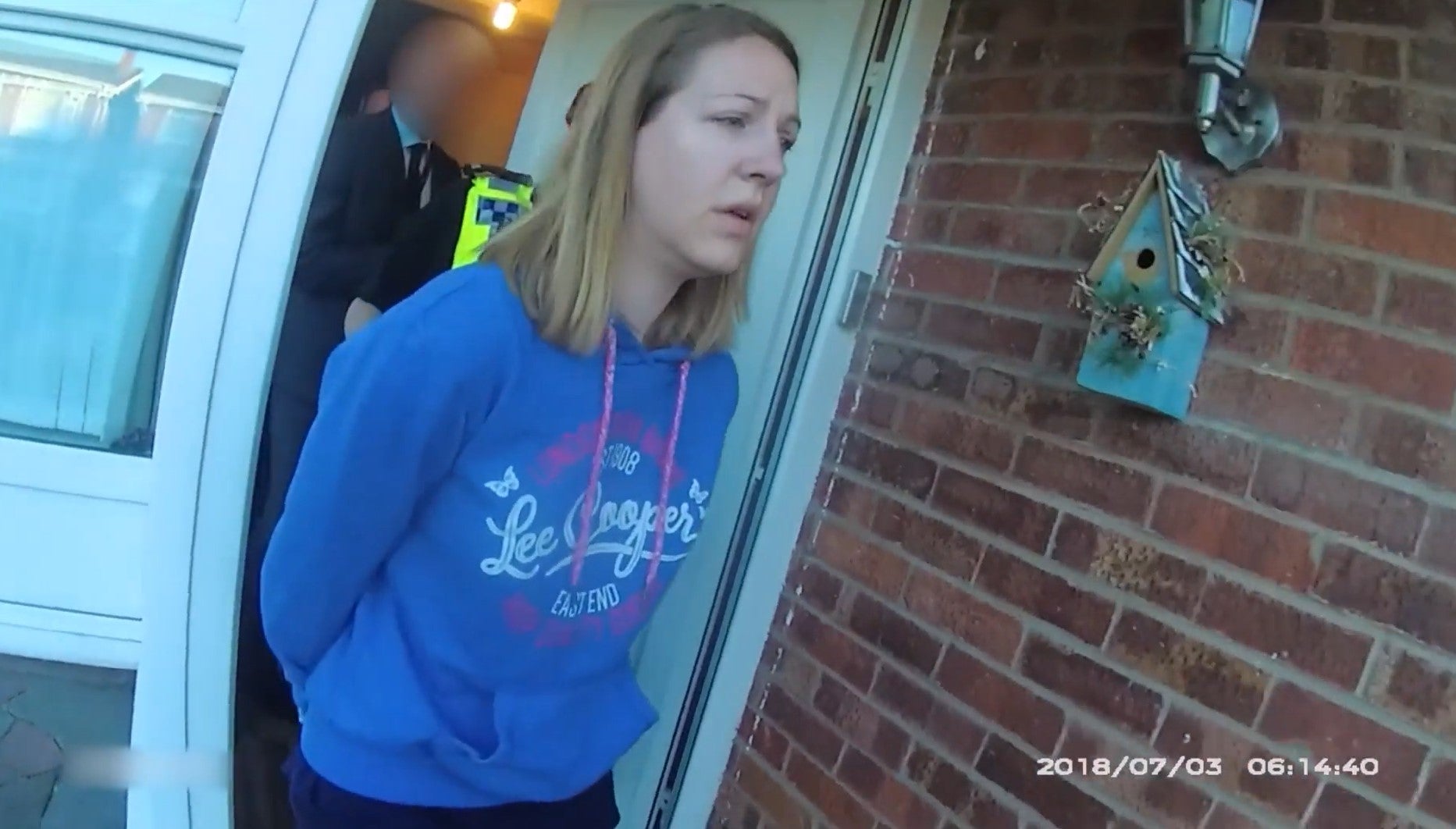 Lucy Letby is led away in cuffs from her home