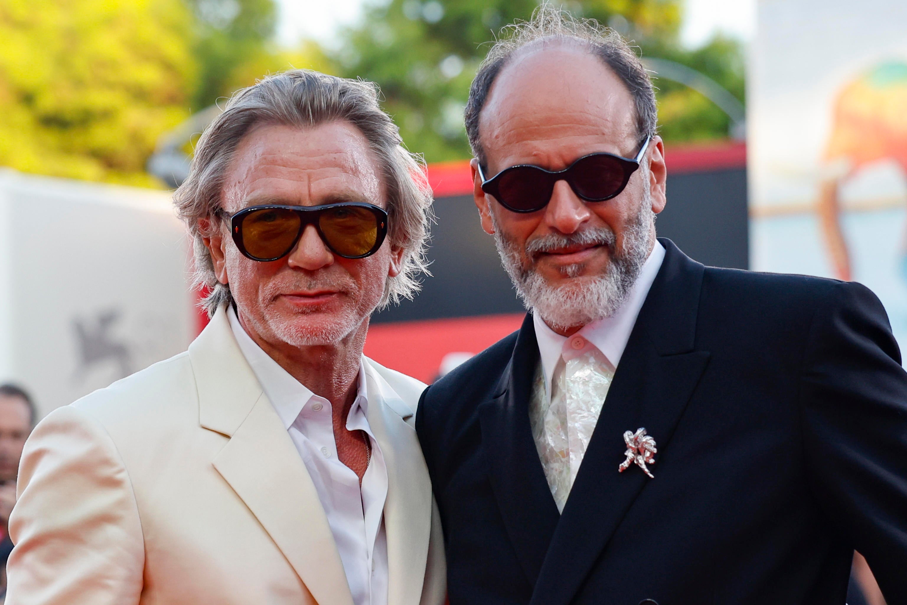 Italian director Luca Guadagnino (R) and British actor Daniel Craig attend the premiere of the film 'Queer' during the 81st annual Venice International Film Festival