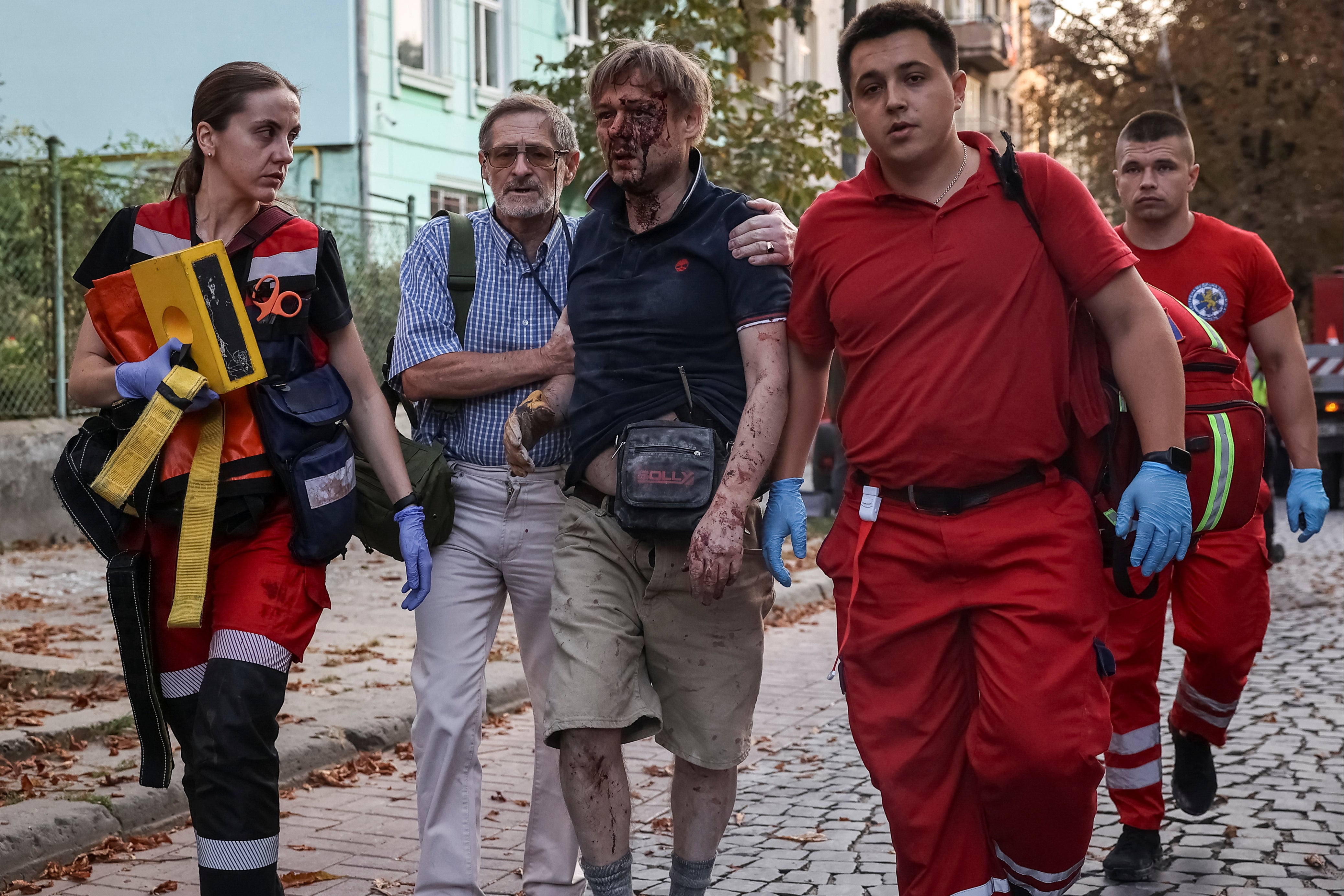 Injured Lviv resident Yaroslav Bazylevych (centre) is led away by medics after losing his wife and three daughters during yesterday’s missile and drone strike