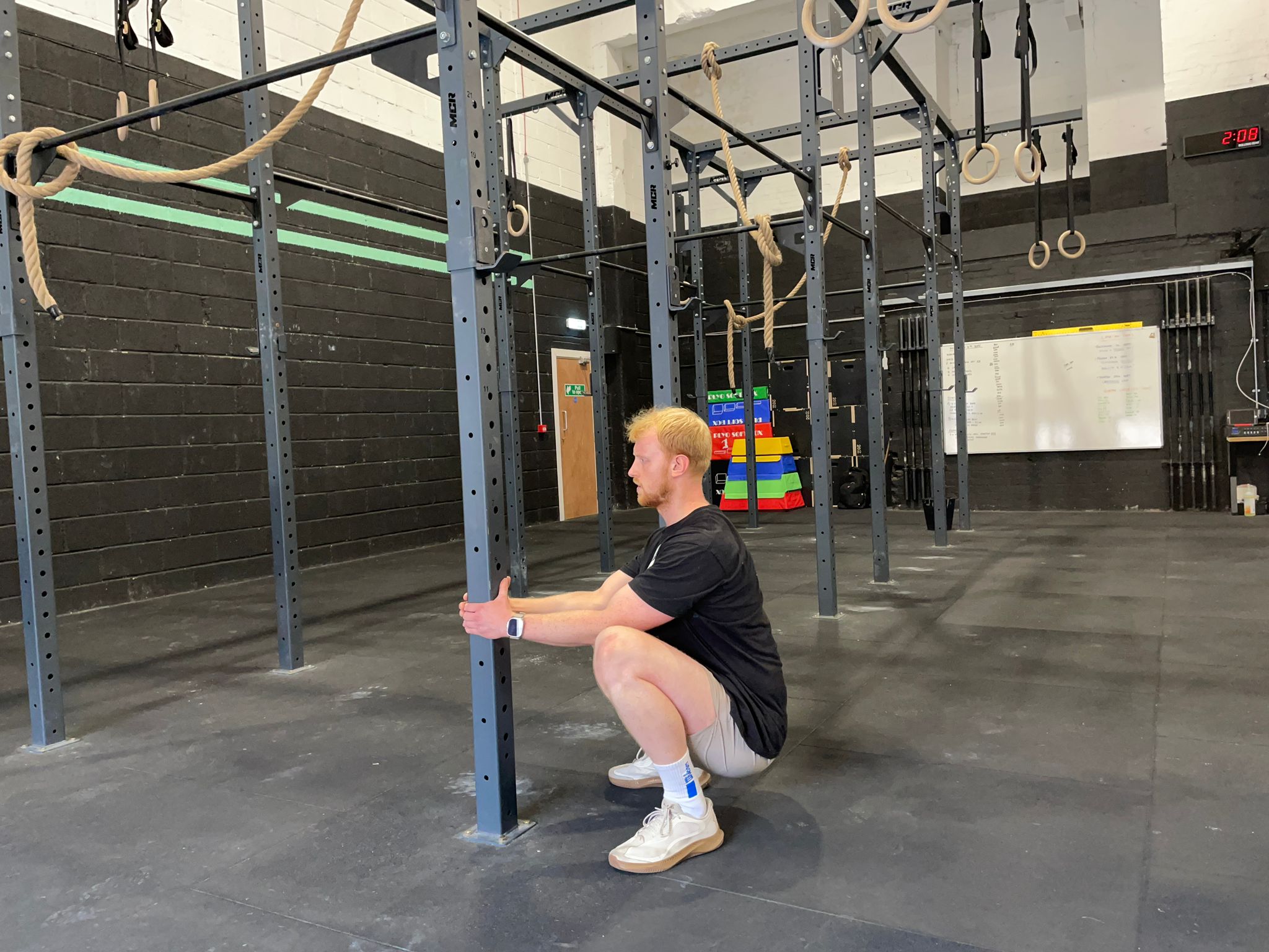 Fitness writer Harry Bullmore holding a squat position