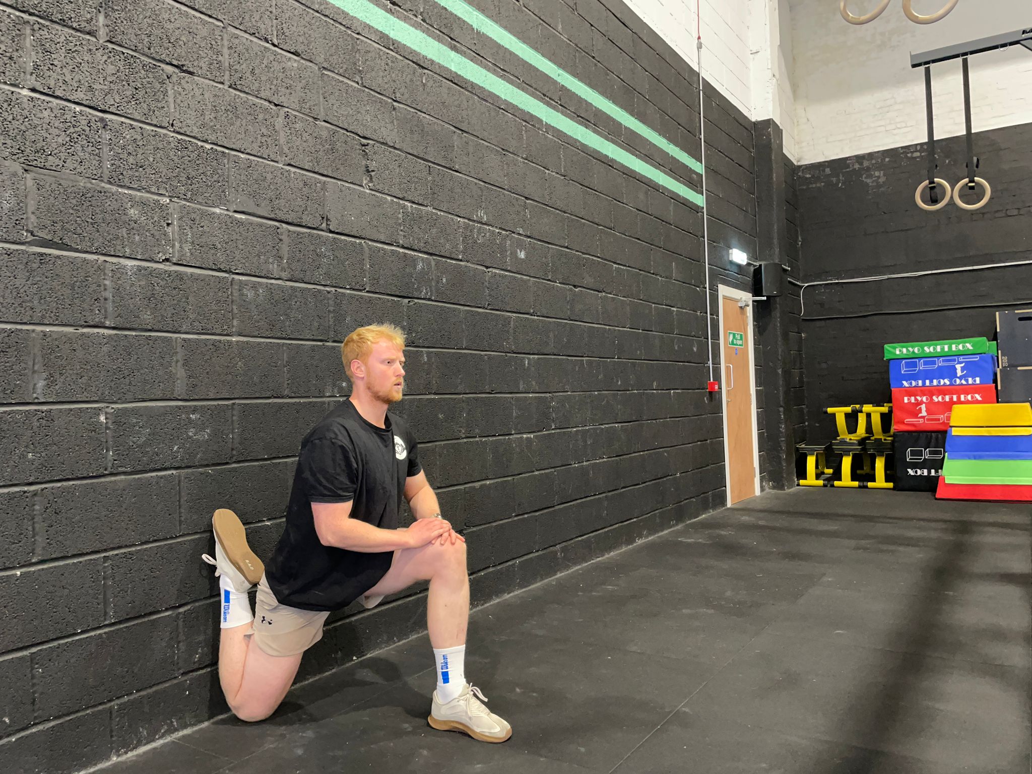 Fitness writer Harry Bullmore doing the couch stretch