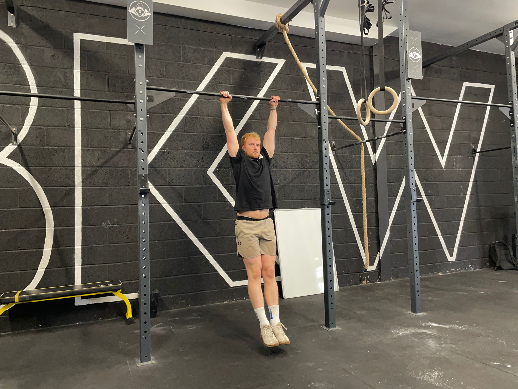 Fitness writer Harry Bullmore in a dead hang position