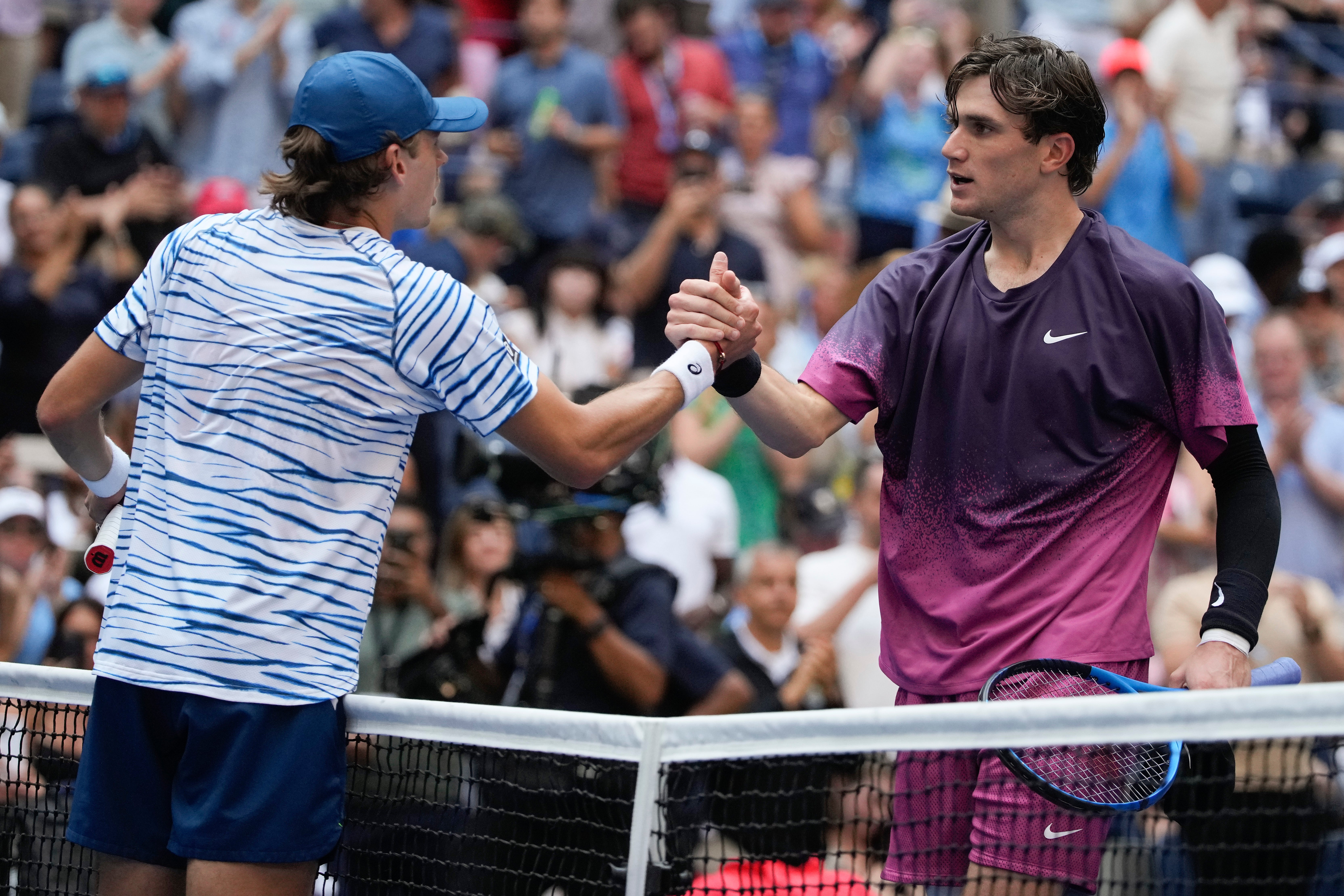 Alex de Minaur (left) appeared to be struggling with injury