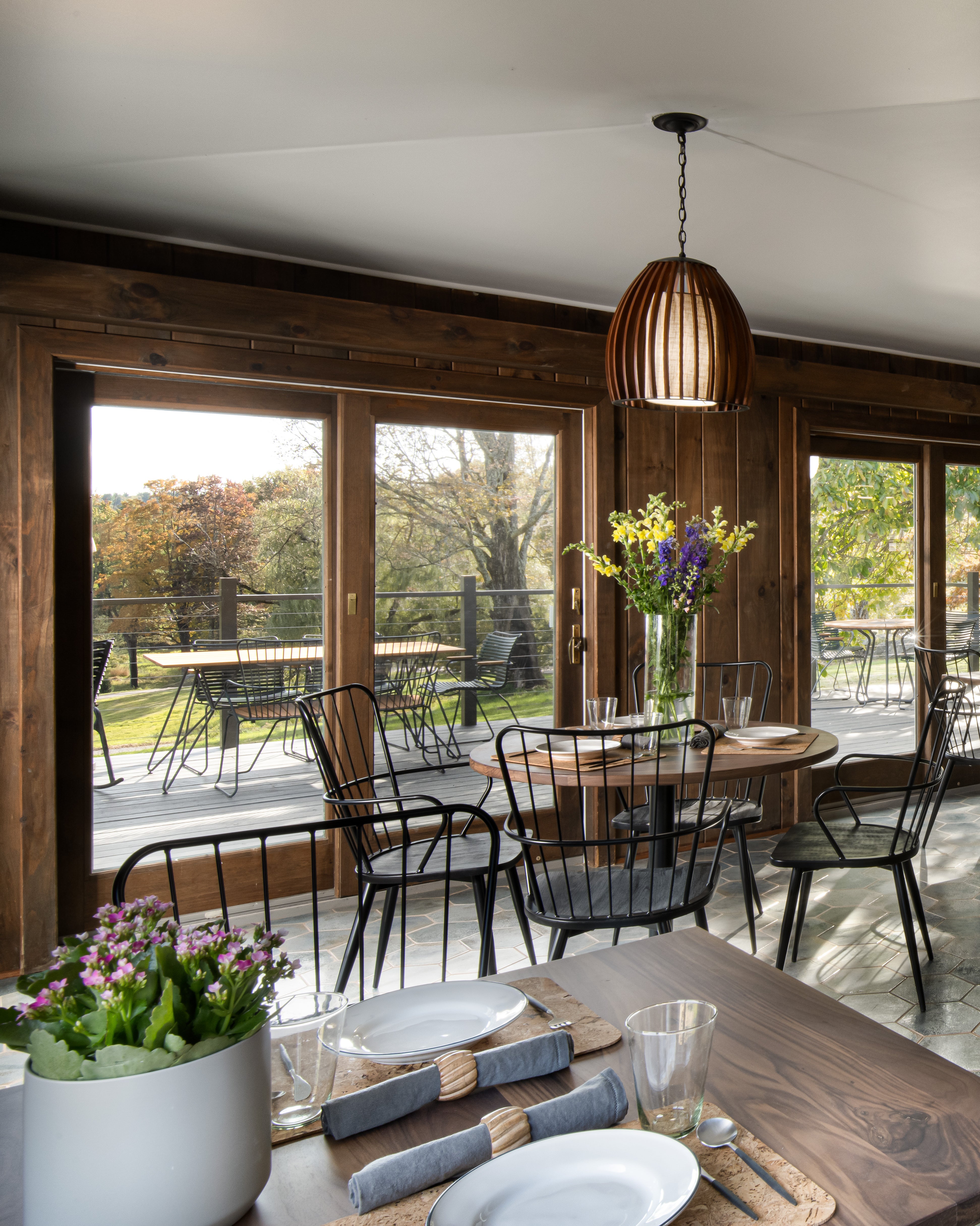 Inside Hemlock Neversink’s main cabin restaurant with a stunning view of the expansive property