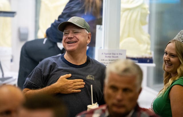 <p>Democratic vice presidential candidate, Tim Walz, speaks with Rachel Visser, the ‘71st Princess Kay of the Milky Way’, as they look at butter sculptures in the Dairy Barn of the Minnesota State Fair on September 1, 2024 in Falcon Heights, Minnesota</p>