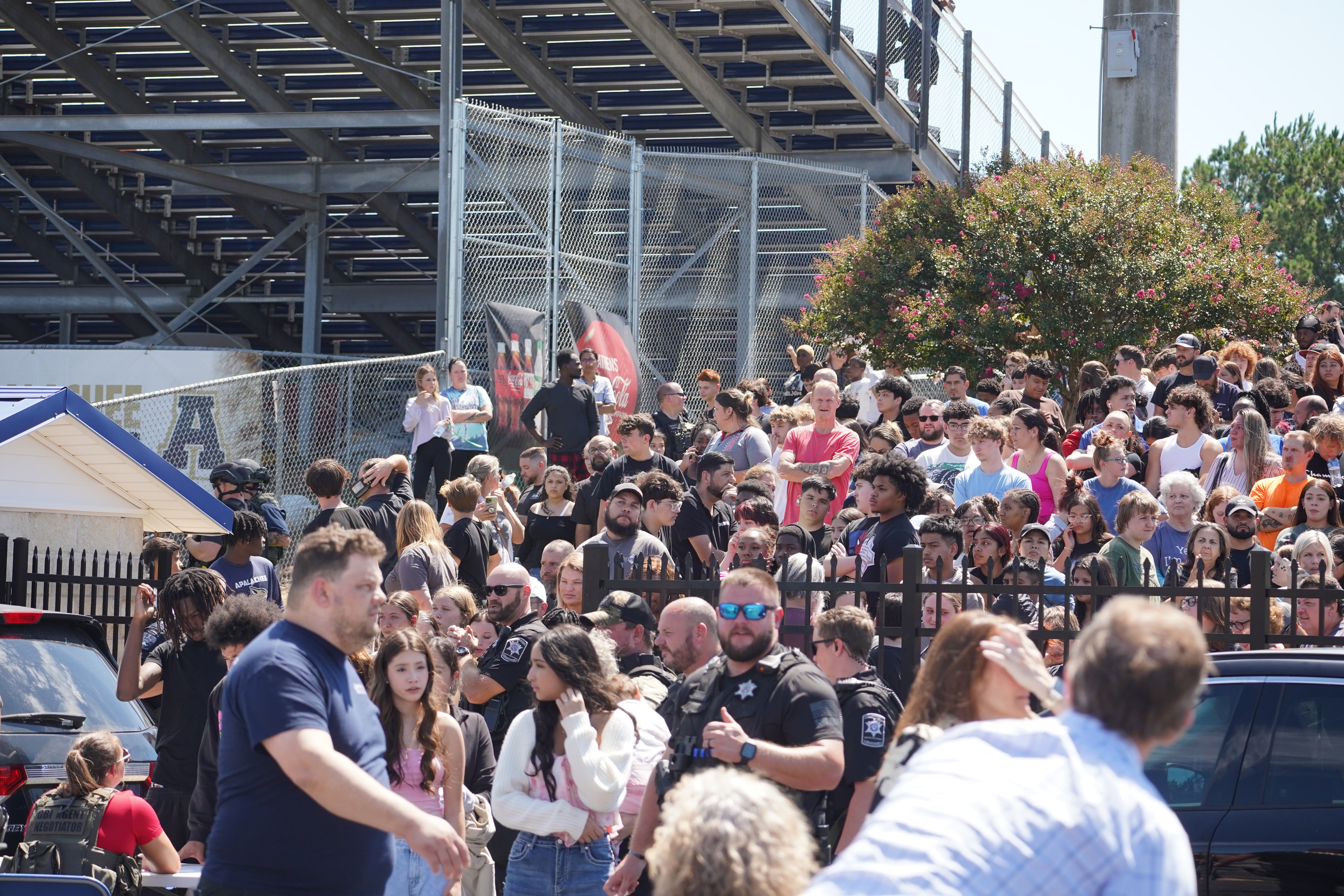 Students wait to be picked up by their parents after a shooting at Apalachee High School on September 4, 2024 in Winder, Georgia