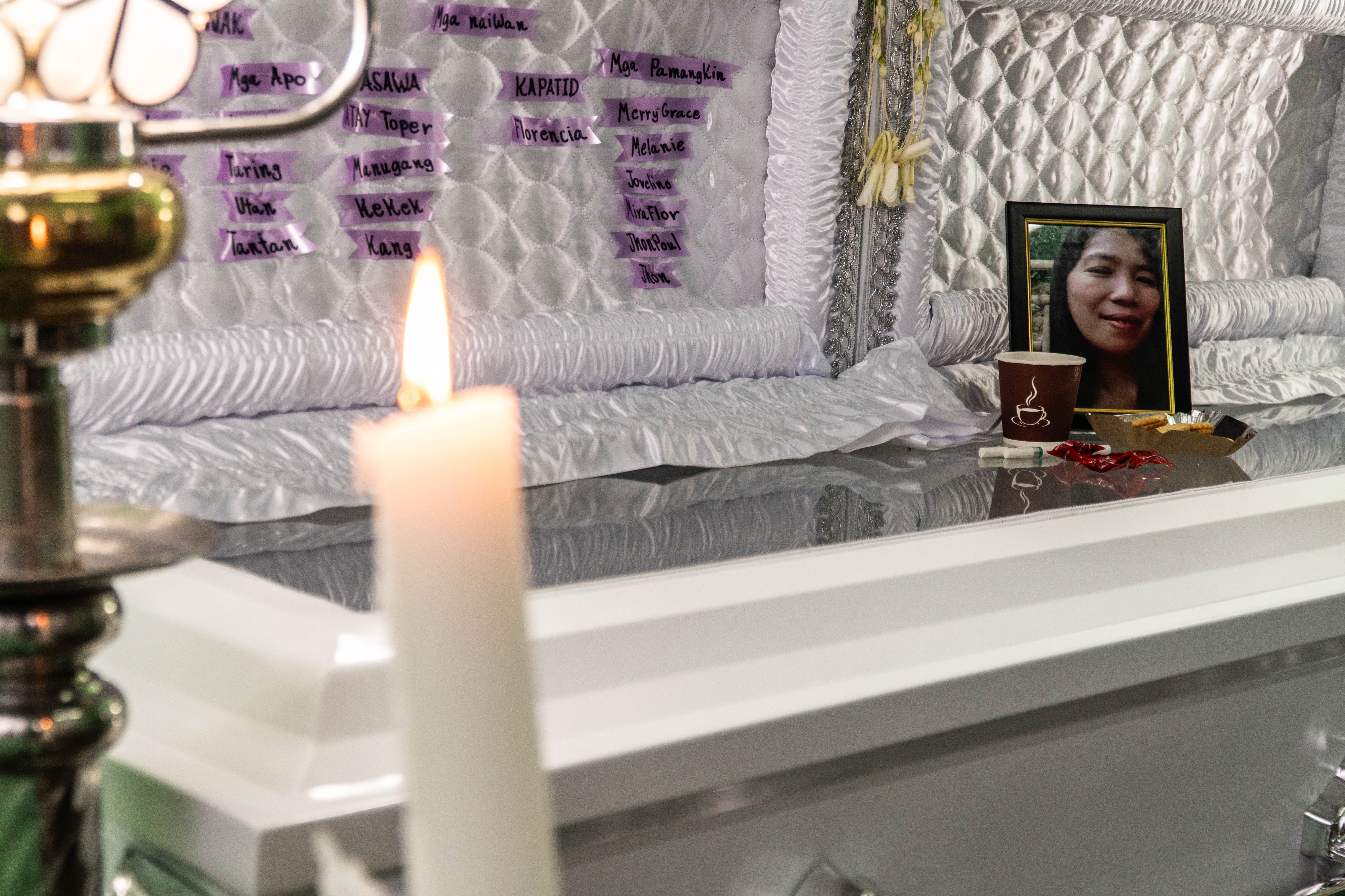 The funeral of Arlin Patangan Calano, 44, who died in the aftermath of Tropical Storm Yagi, is seen with her family in Antipolo, Rizal. Arlin died while saving her siblings and grandchild from the torrential rains.