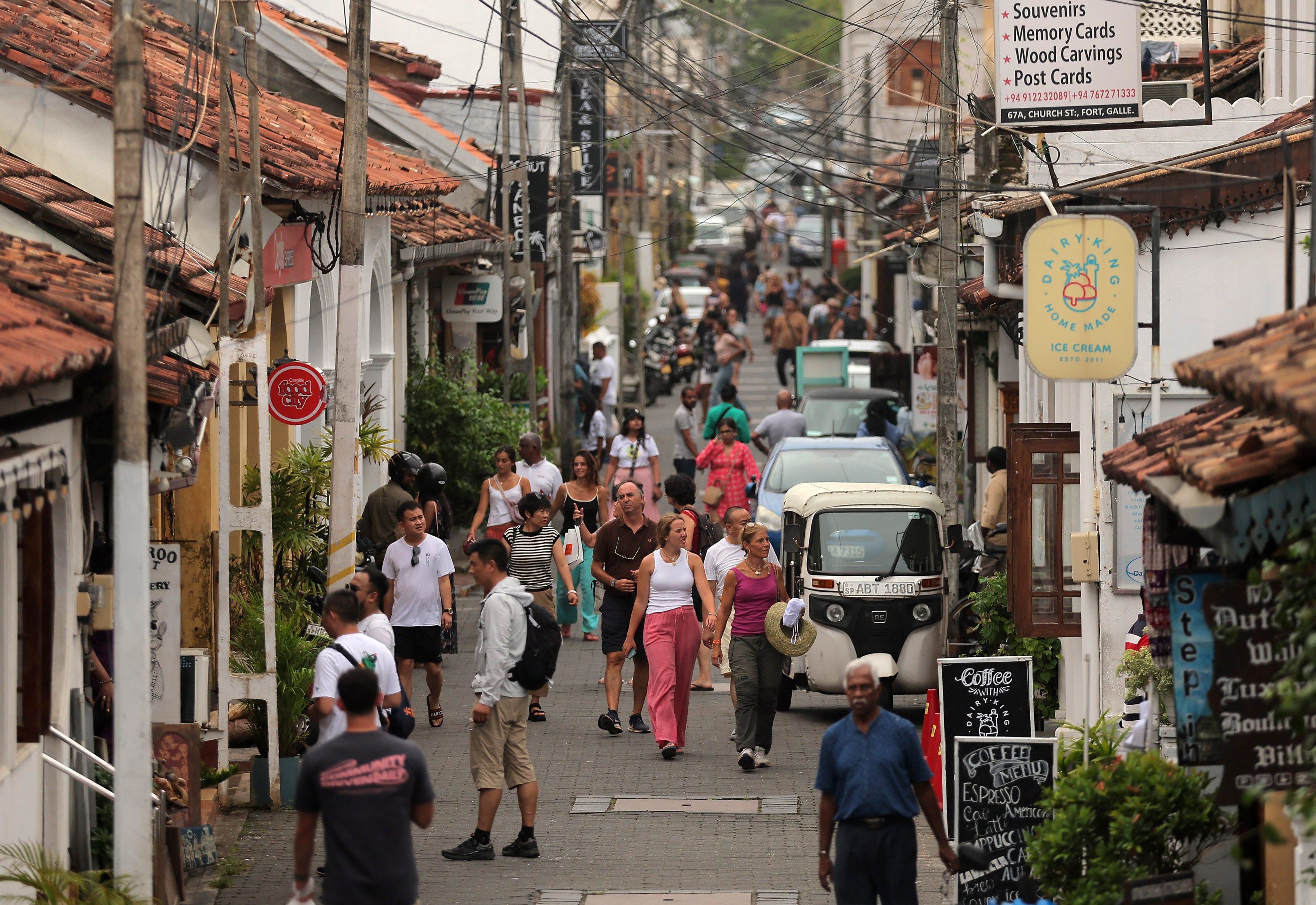 People walk along a road in the Dutch Fort, in Galle, Sri Lanka