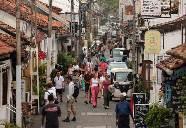 <p>People walk along a road in the Dutch Fort, in Galle, Sri Lanka</p>