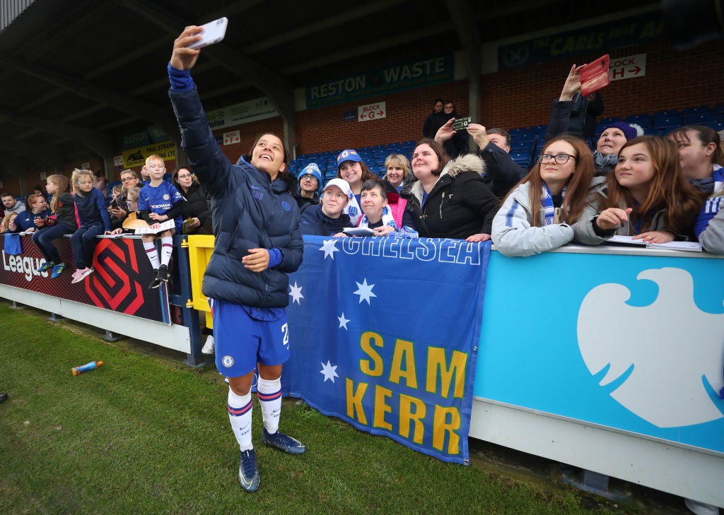 Sam Kerr stops to take a selfie with a group of Chelsea fans at Kingsmeadow