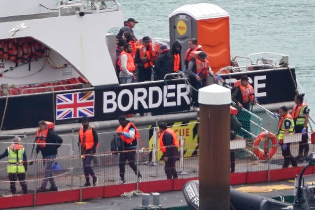 <p>A group of people thought to be migrants are brought in to Dover, Kent, from a Border Force vessel</p>