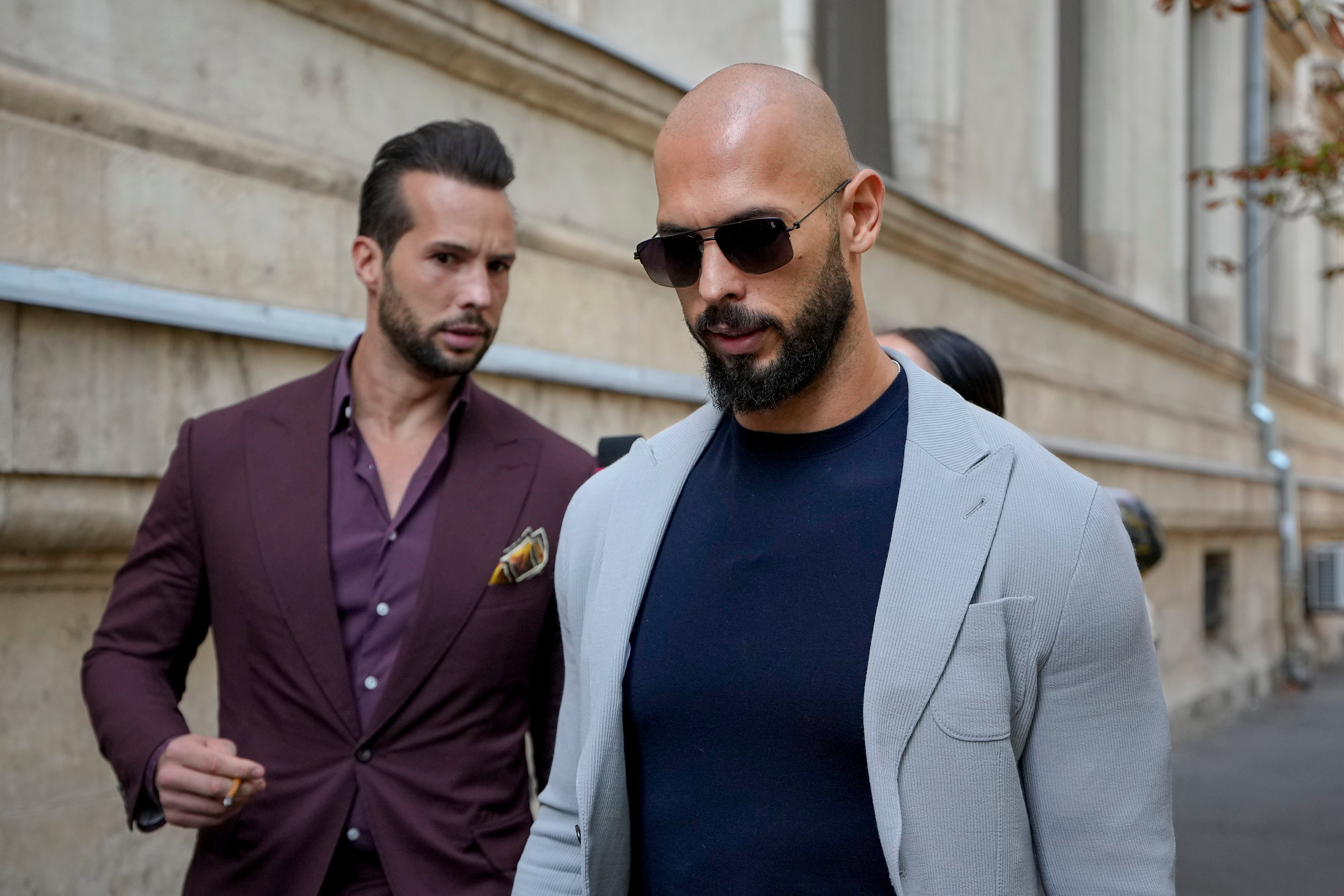 Andrew Tate and his brother Tristan, left, at a separate hearing, in Bucharest, Romania, in September