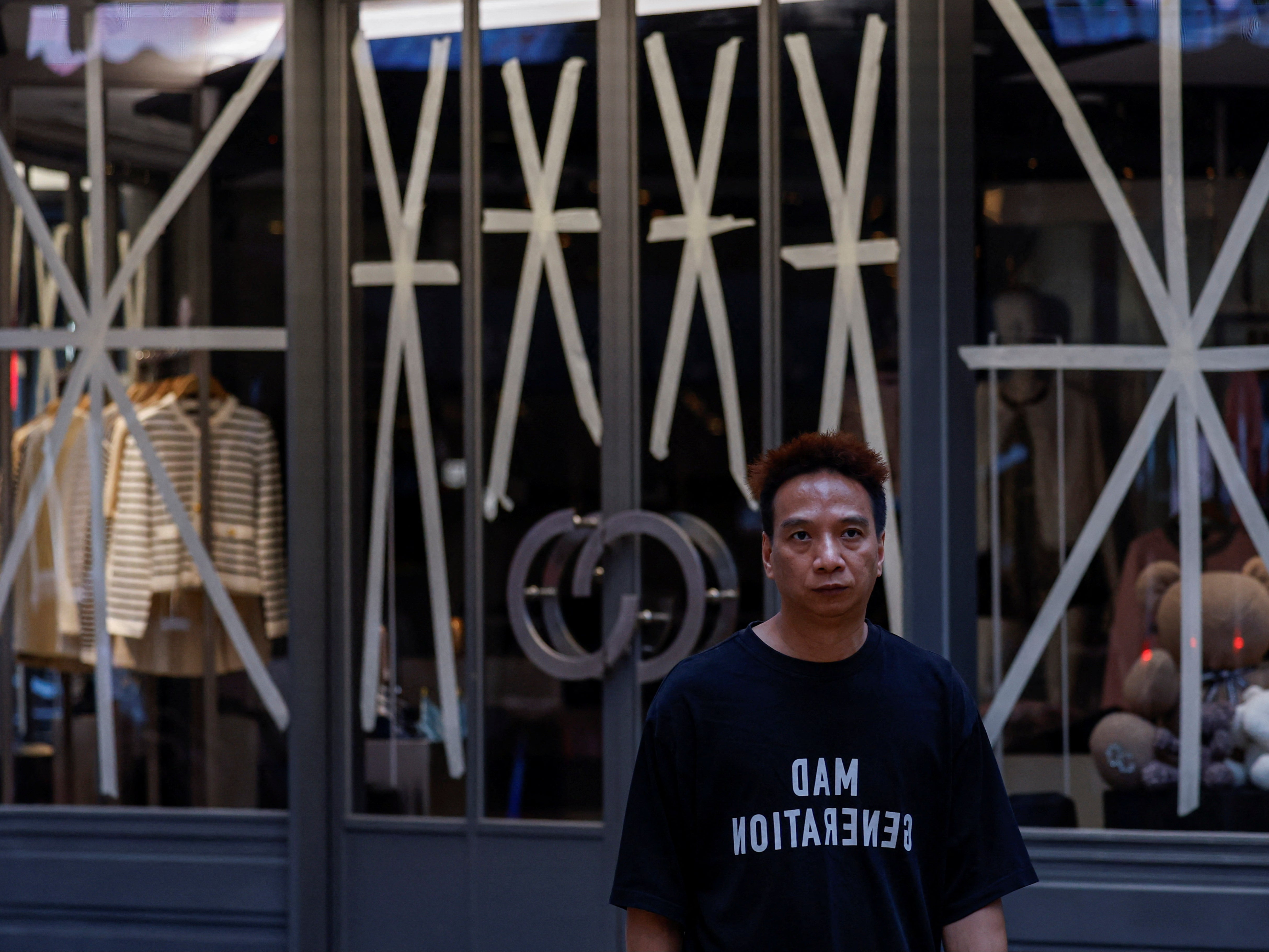 A window is taped in anticipation of typhoon Yagi at a clothing store in Hong Kong