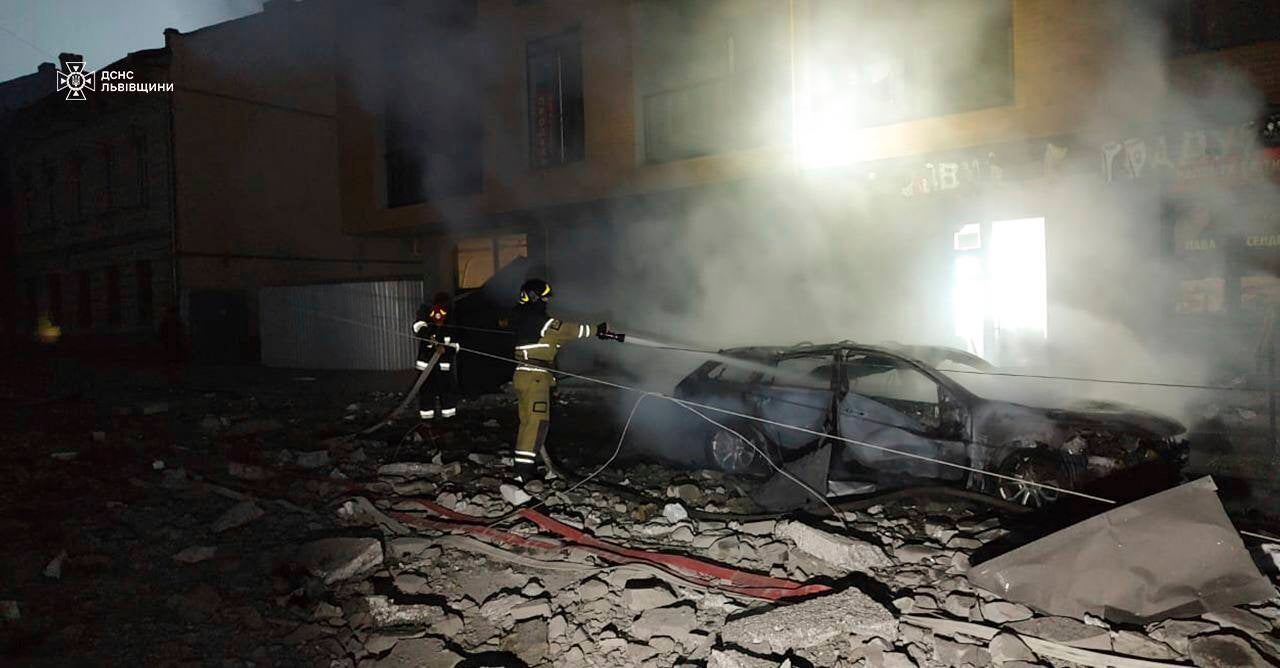 A rescue worker extinguishes a fire in a car destroyed by a Russian strike in Lviv, Ukraine (State Emergency Service of Ukraine via AP)