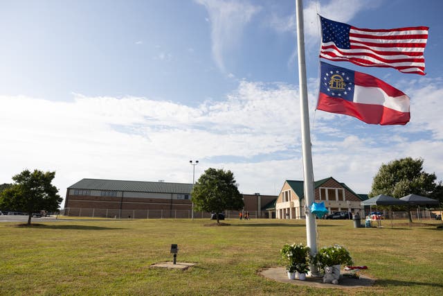 <p>Flags are at half-mast and flowers lay outside of Apalachee High School on September 5, 2024 in Winder, Georgia</p>