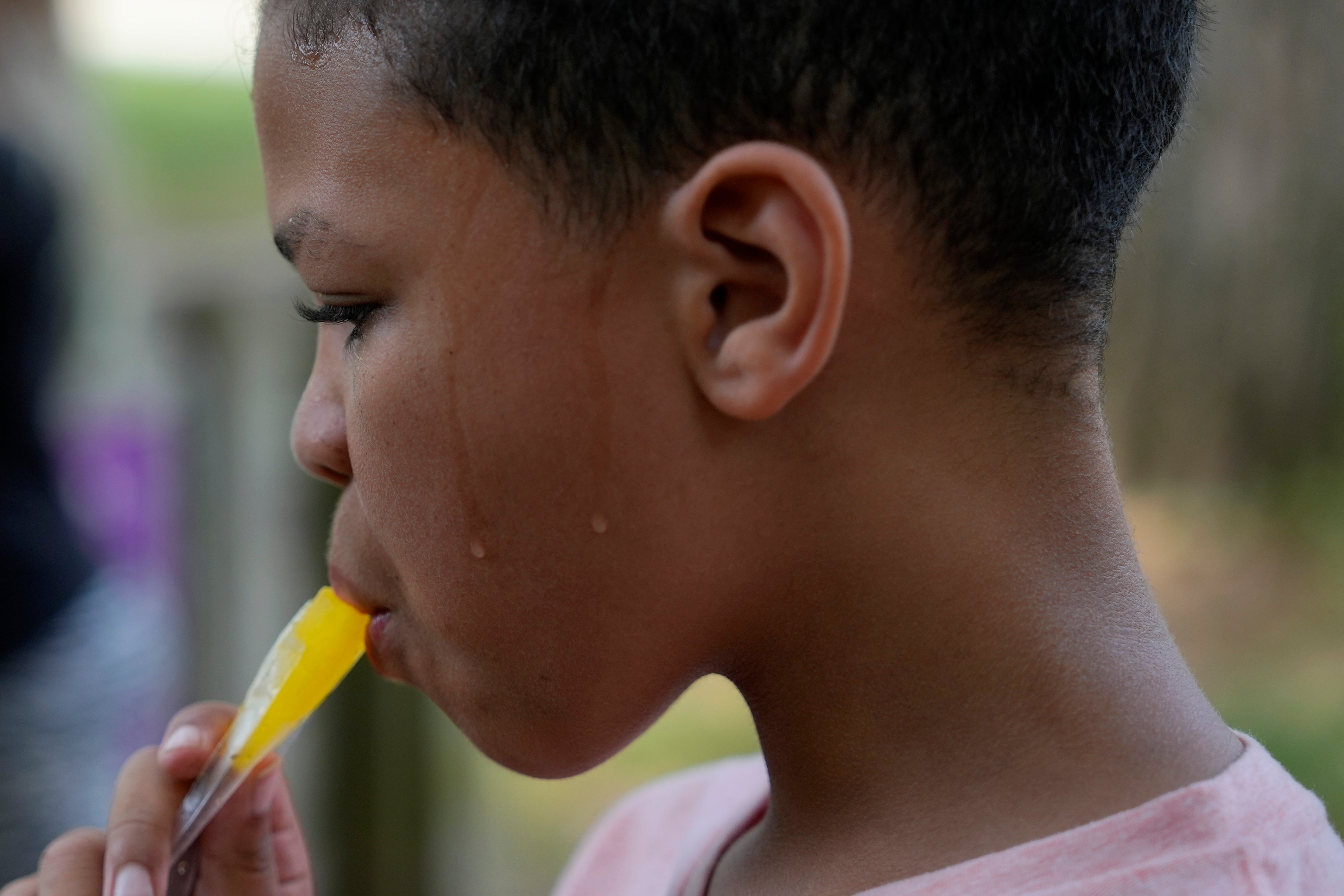 ariah Fields eats a popsicle, June 20, 2024, at YMCA Camp Kern in Oregonia, Ohio. (