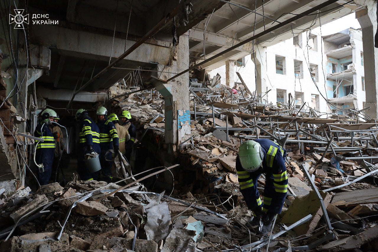 Ukrainian rescuers working in the military communications institute in Poltava